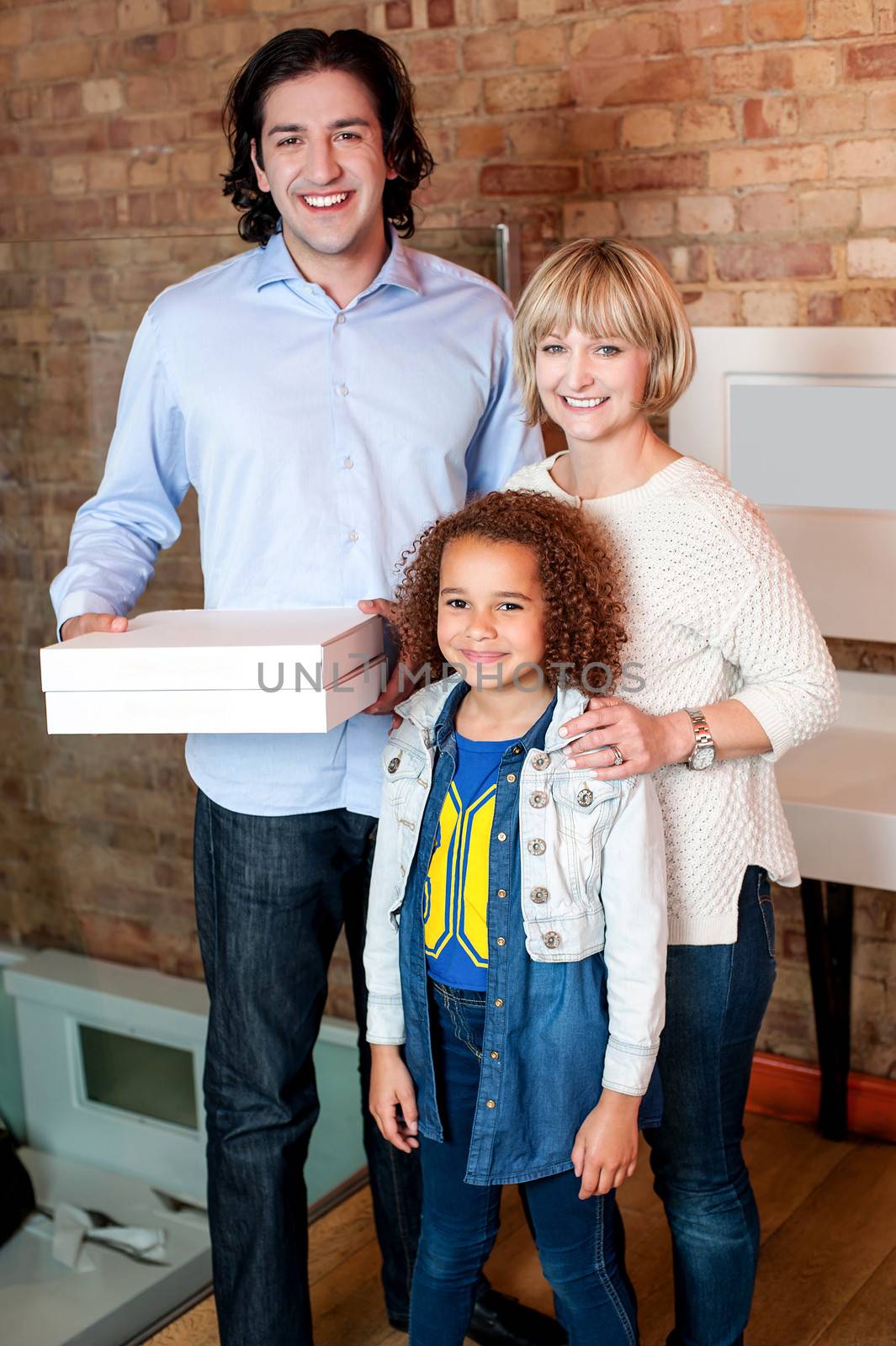 Young man with his family holding pizza boxes