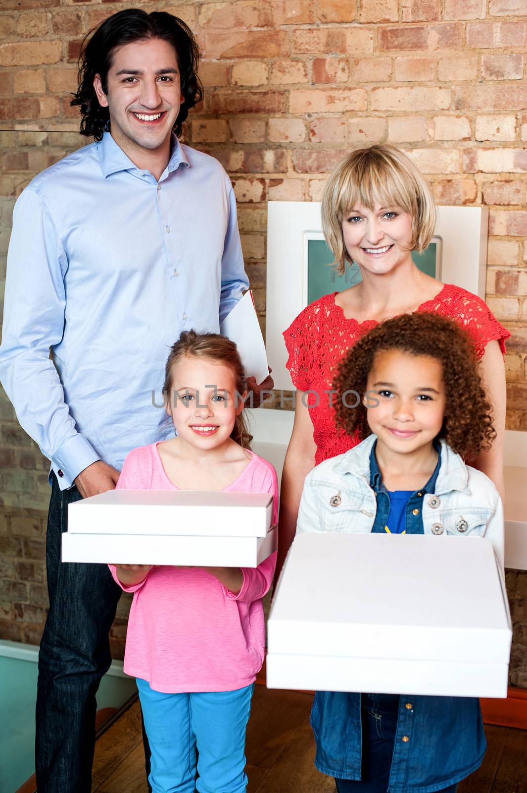 Beautiful little girls holding pizza boxes by stockyimages
