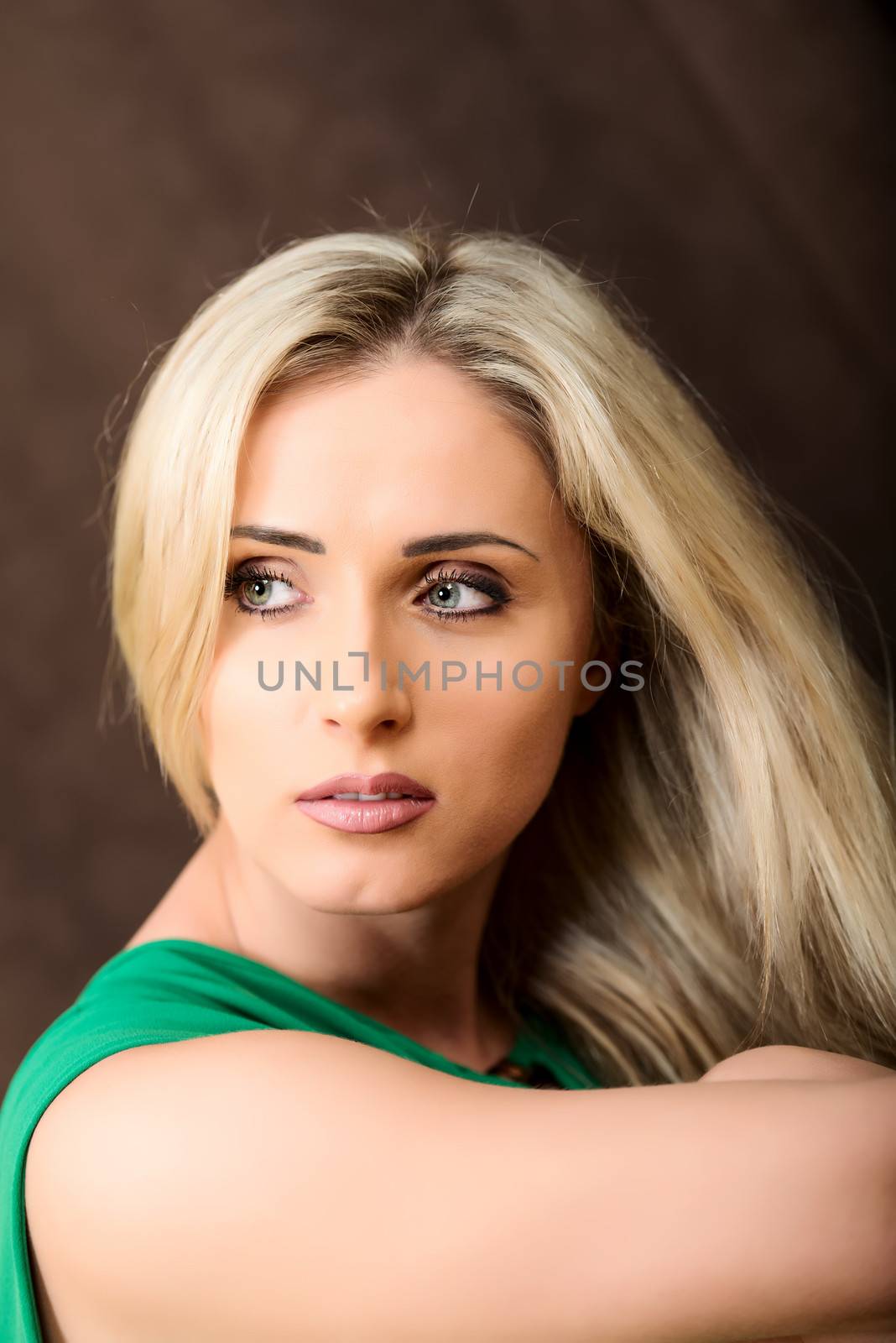 Blond woman in green dress portrait