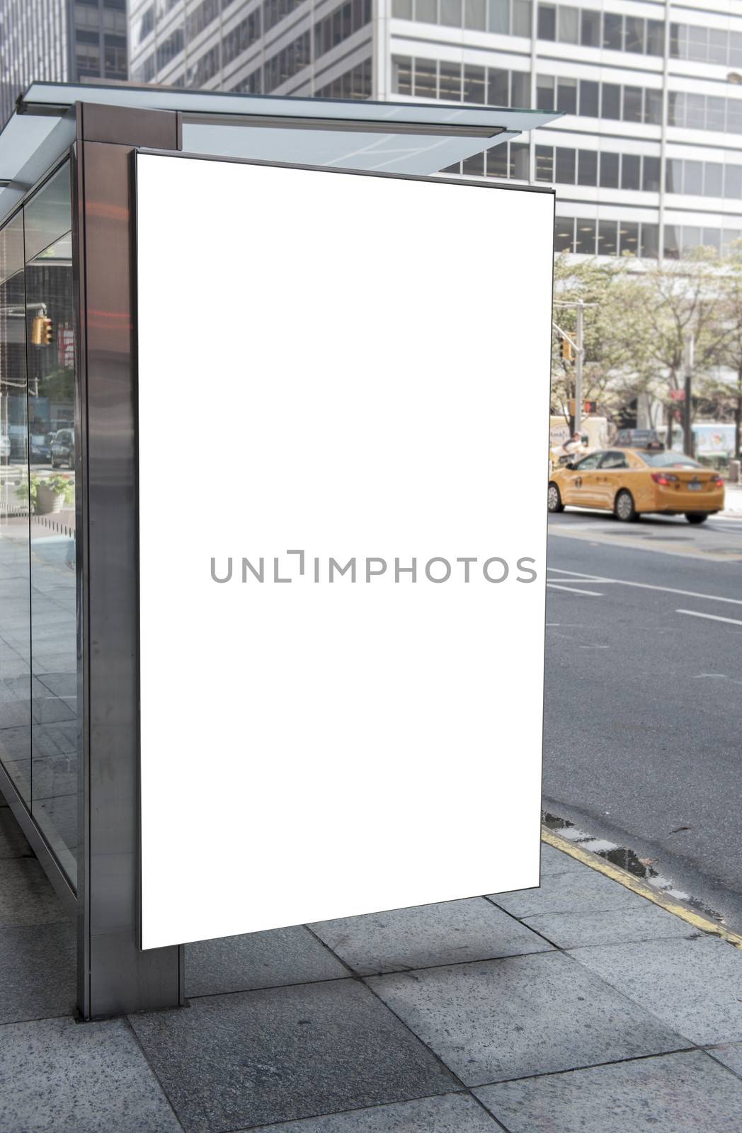 An empty white billboard at a bus stop