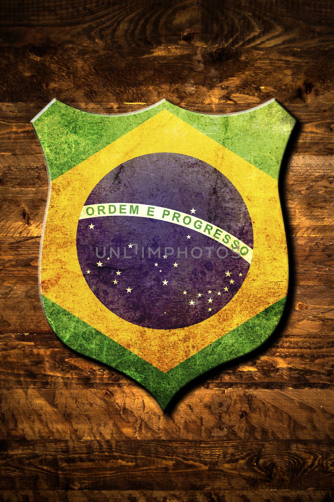 A metal Brazil shield on a wooden background