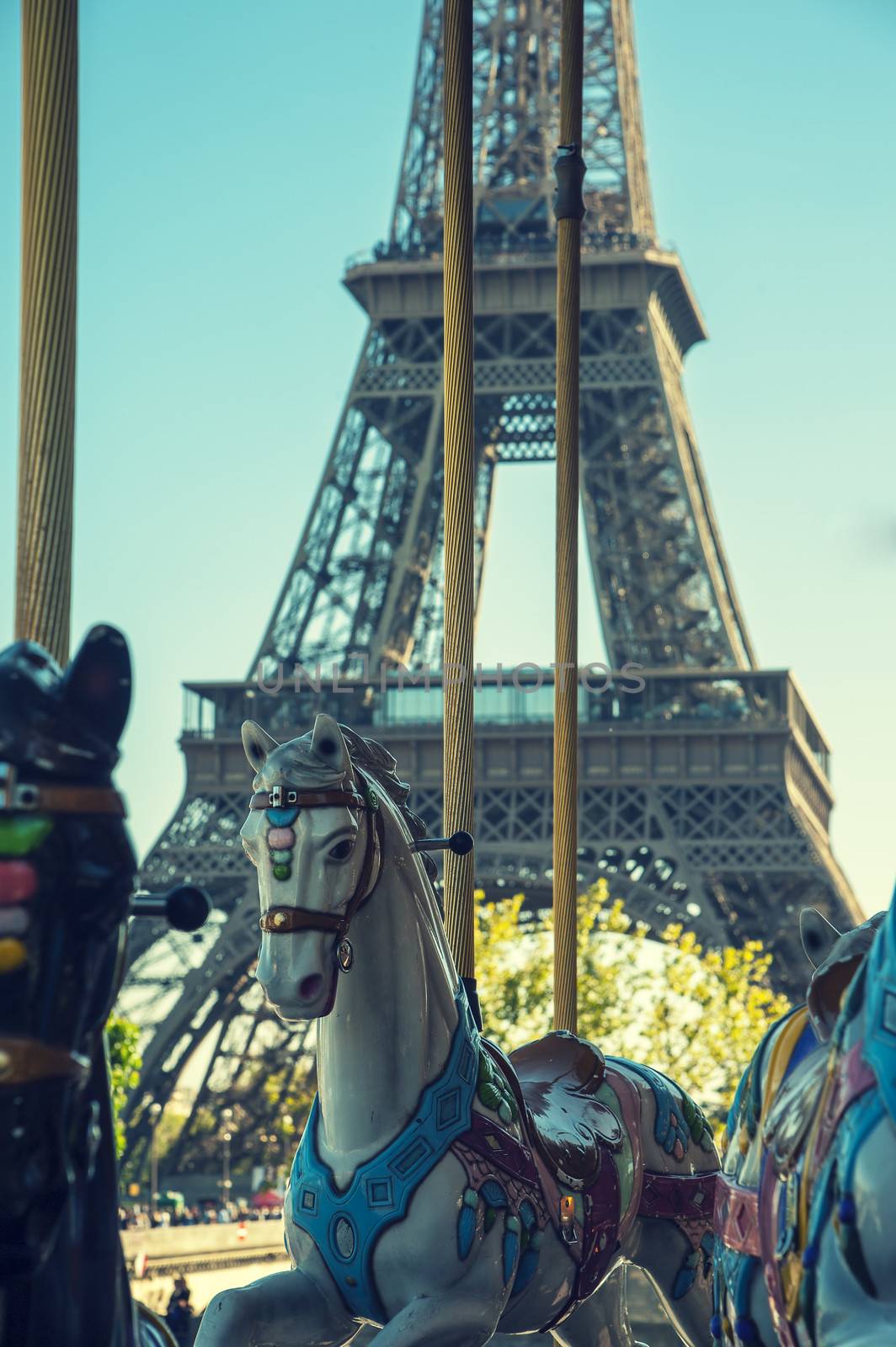 Vintage carousel with white horses in Paris