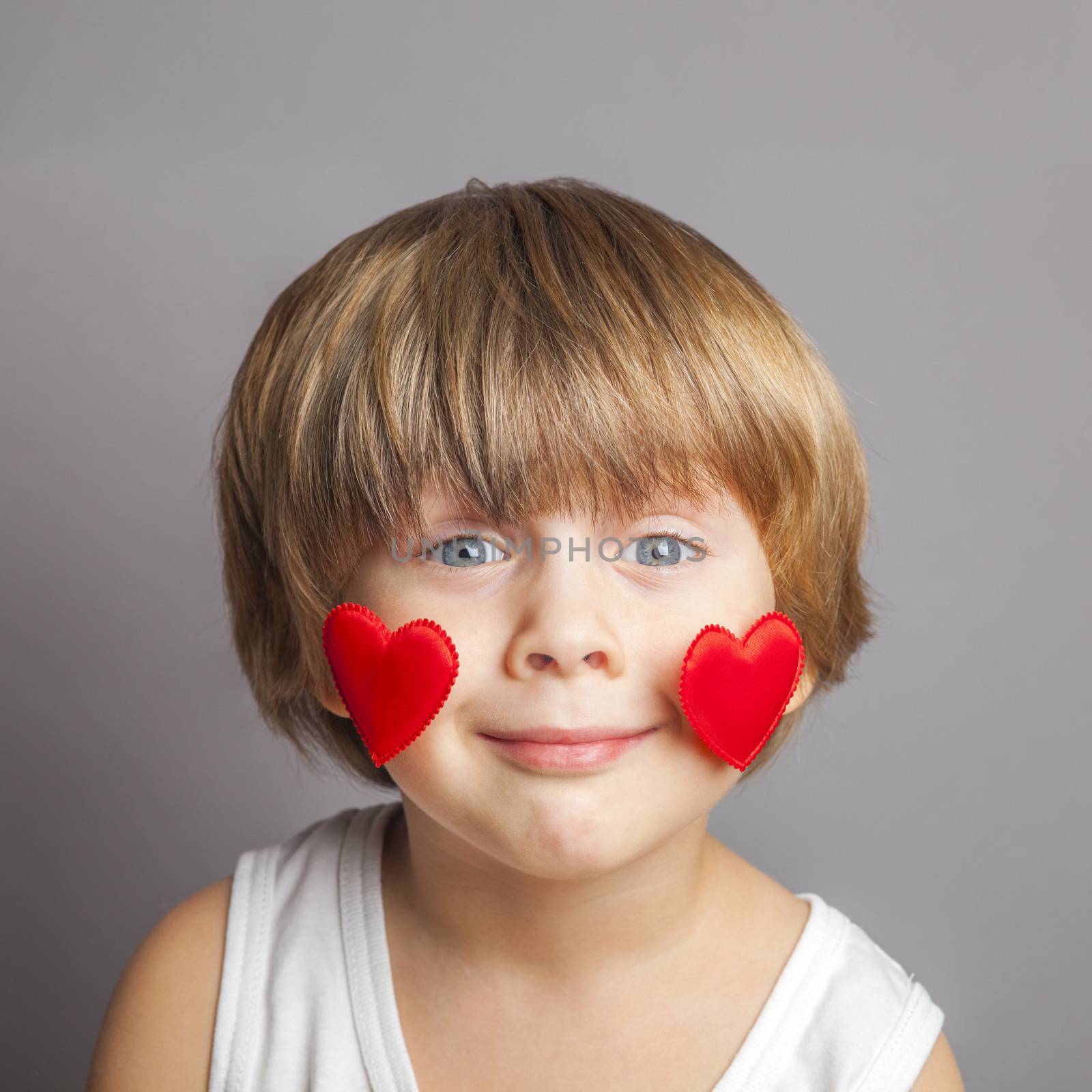 Portrait of a boy with hearts on face