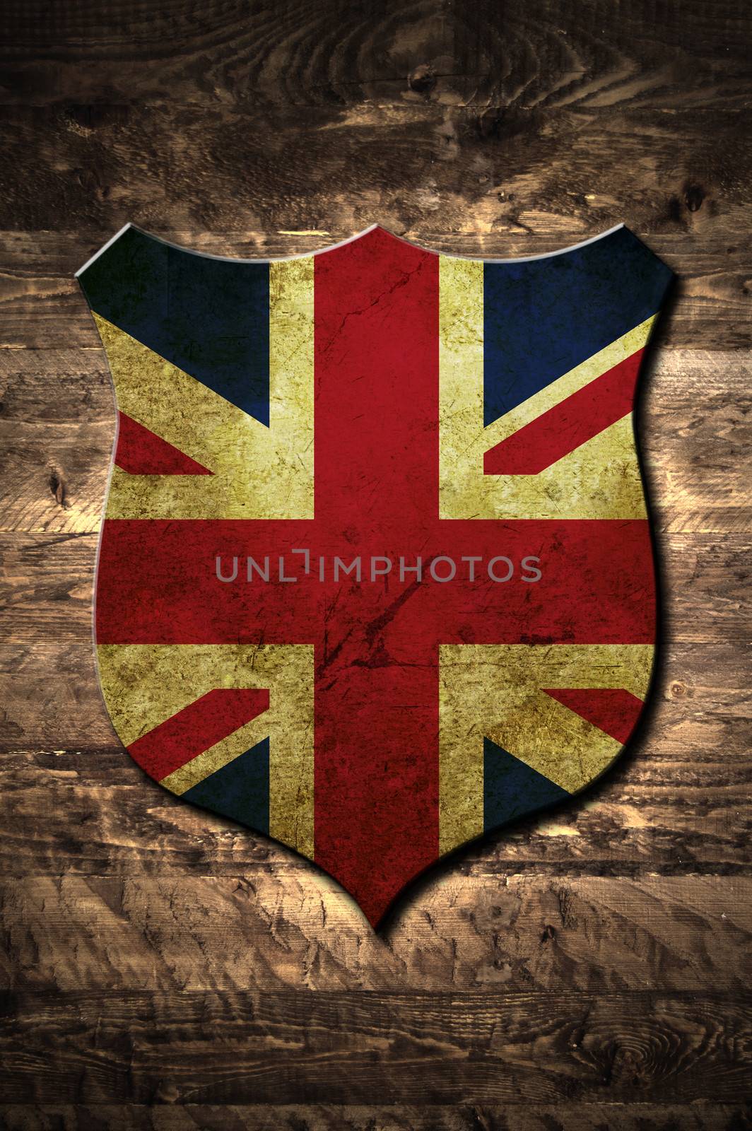 A metal United Kingdom shield on a wooden background