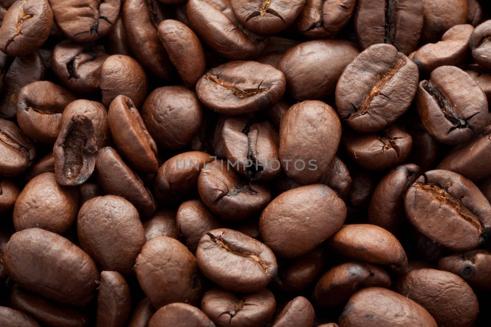 Close-up of brown coffee beans, background texture