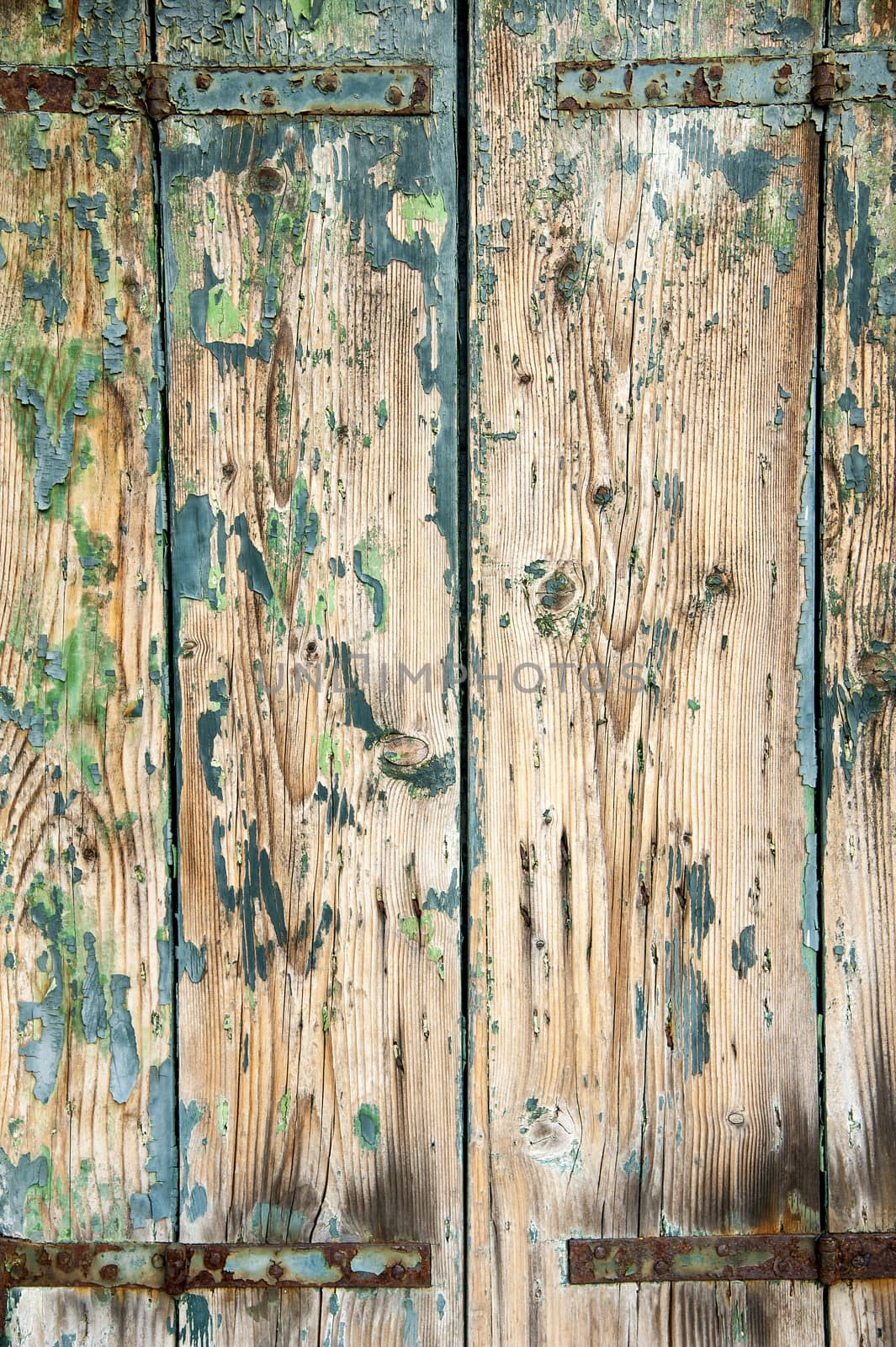 Old wooden painted light green rustic background, paint peeling