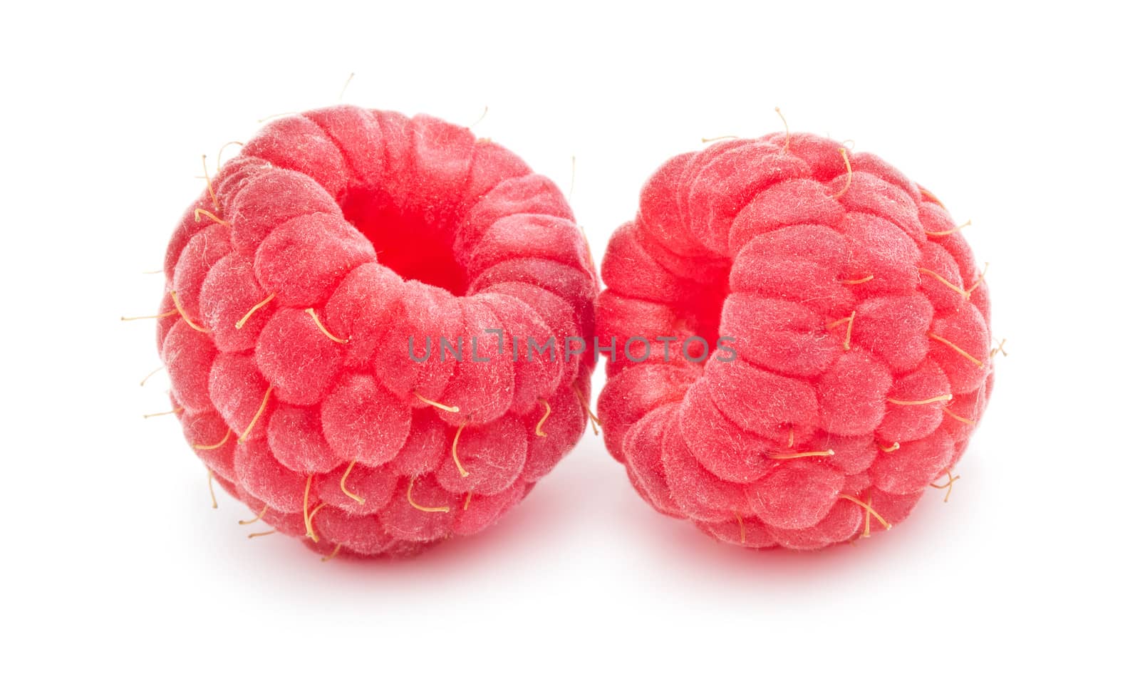 Ripe red raspberries isolated on white background