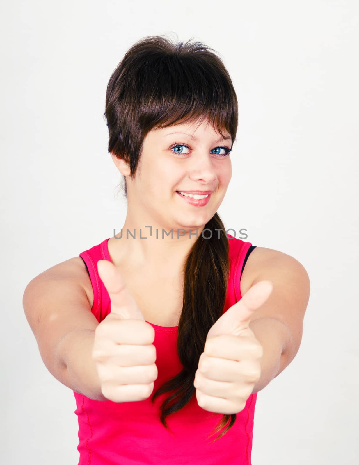 Young positive woman with thumbs up. portrait