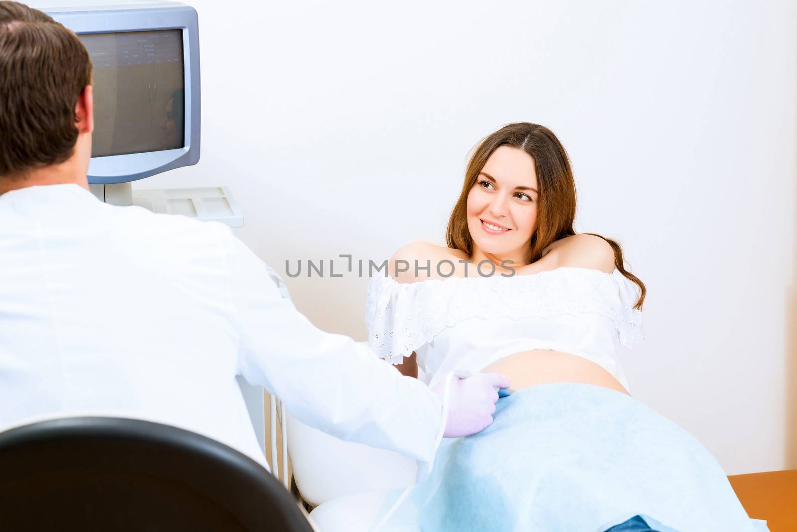 Young attractive pregnant woman on reception at the doctor, health check