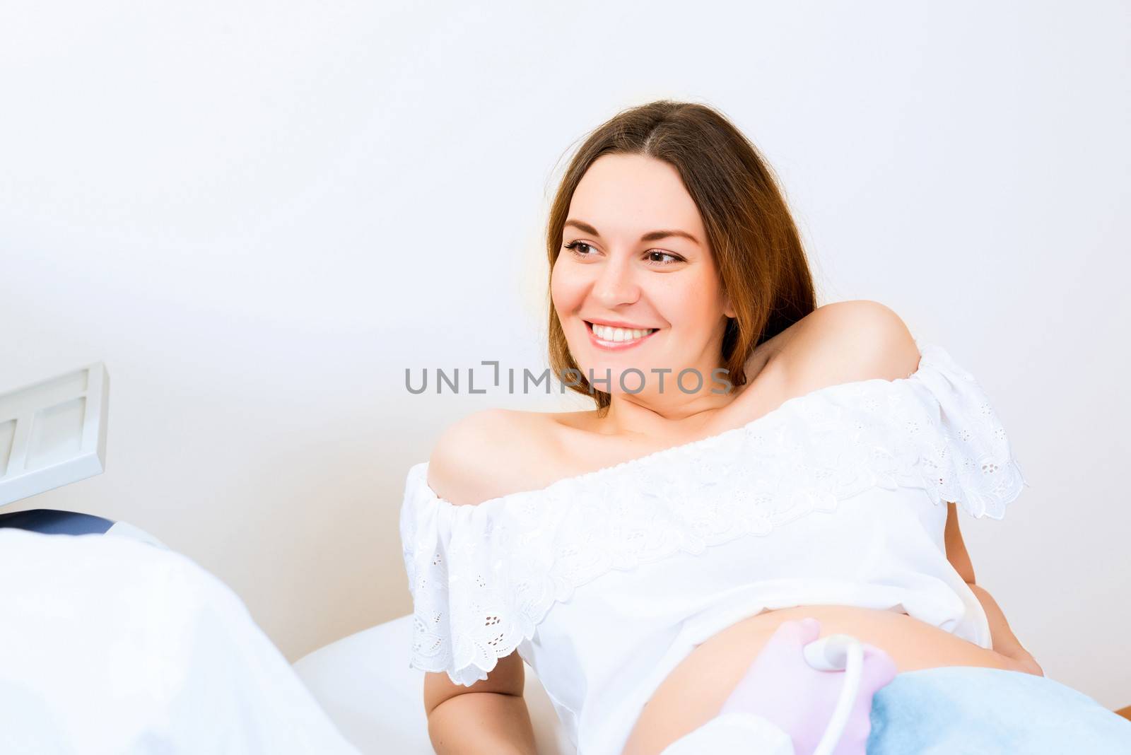 Young attractive pregnant woman on reception at the doctor, health check