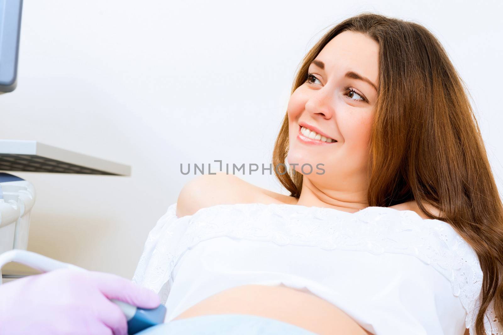 Young attractive pregnant woman on reception at the doctor, health check