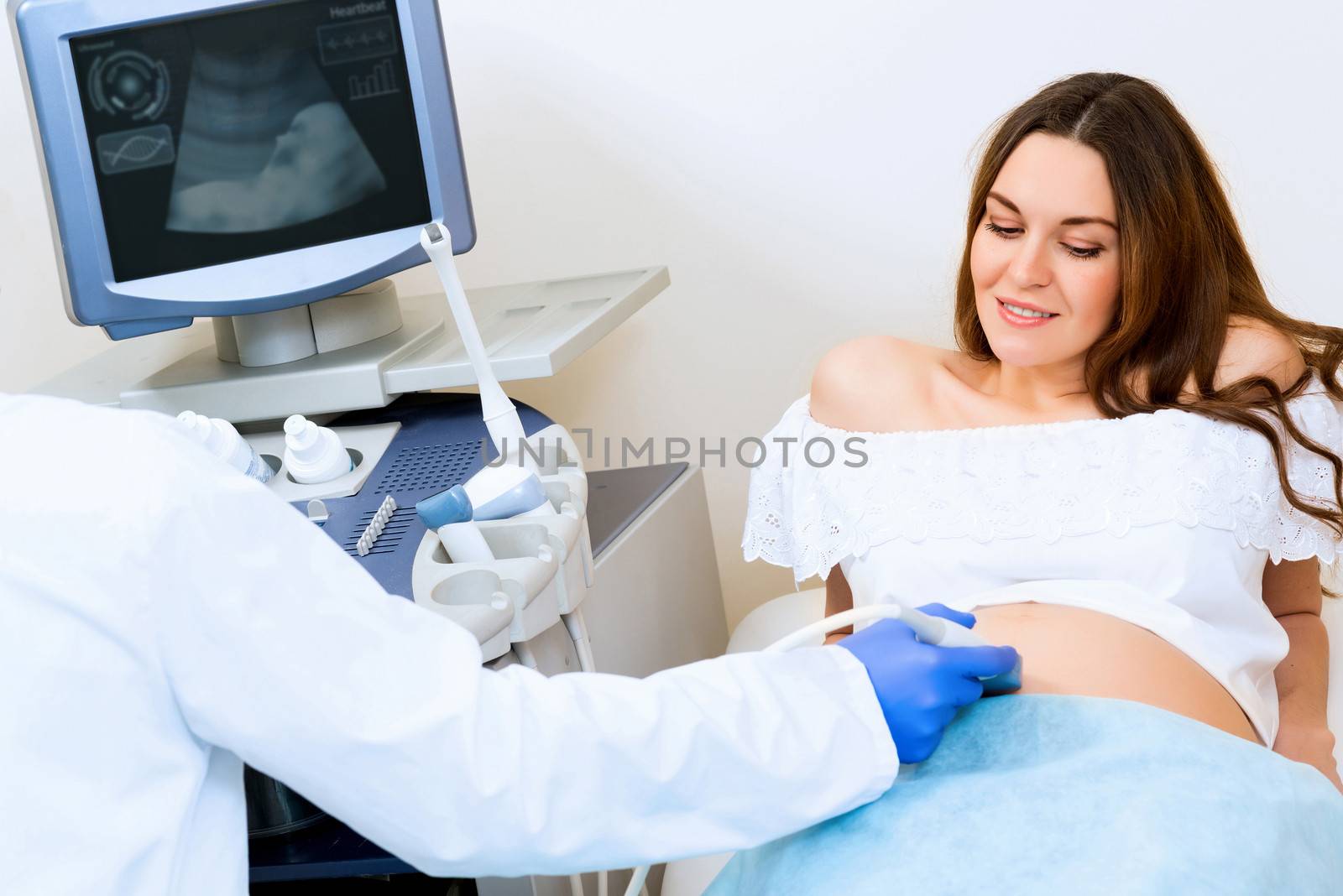 Young attractive pregnant woman on reception at the doctor, health check