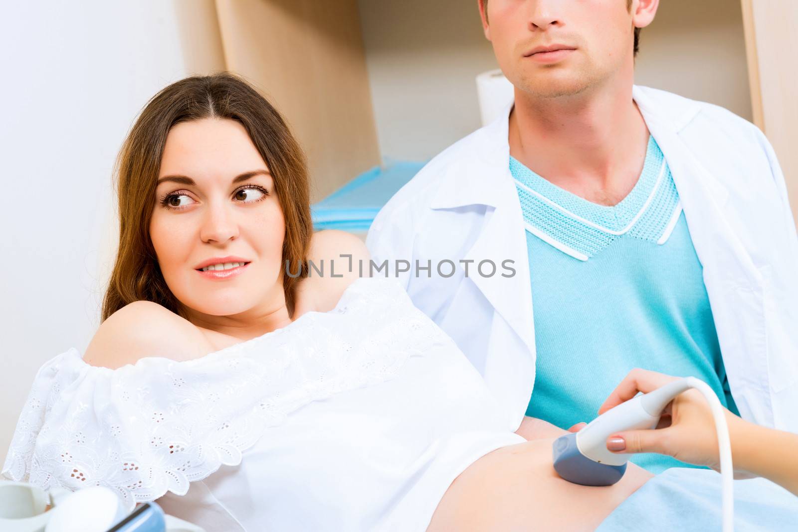 pregnant woman and the future father of the doctor's office, ultrasound diagnostics