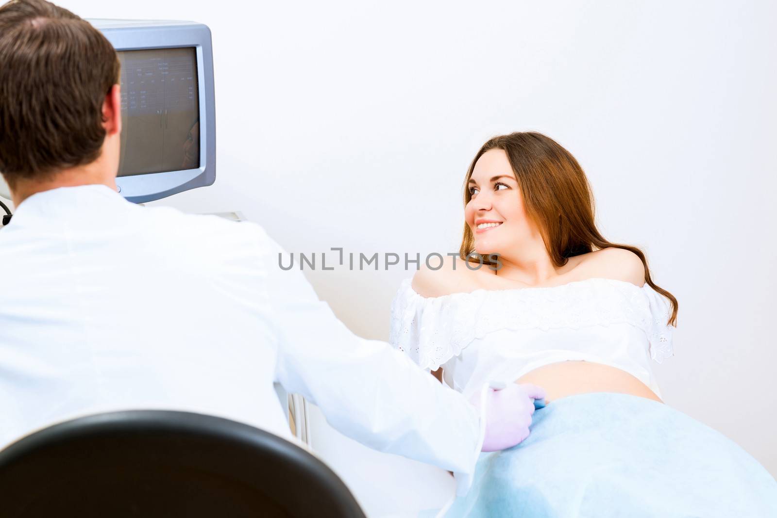 pregnant woman on reception at the doctor by adam121