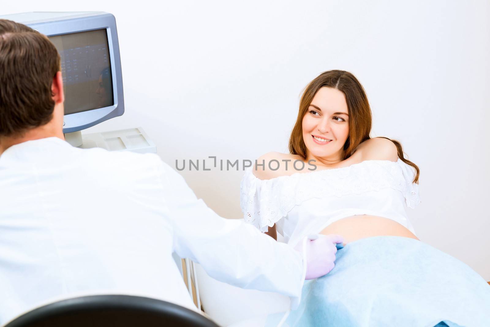 Young attractive pregnant woman on reception at the doctor, health check