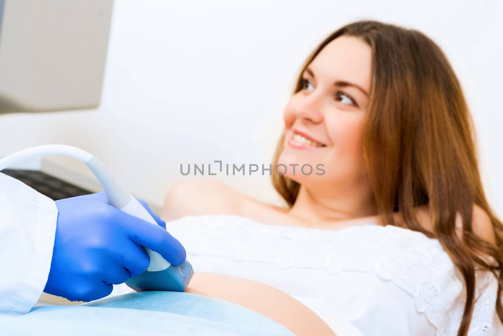 close-up of hands and abdominal ultrasound scanner by adam121