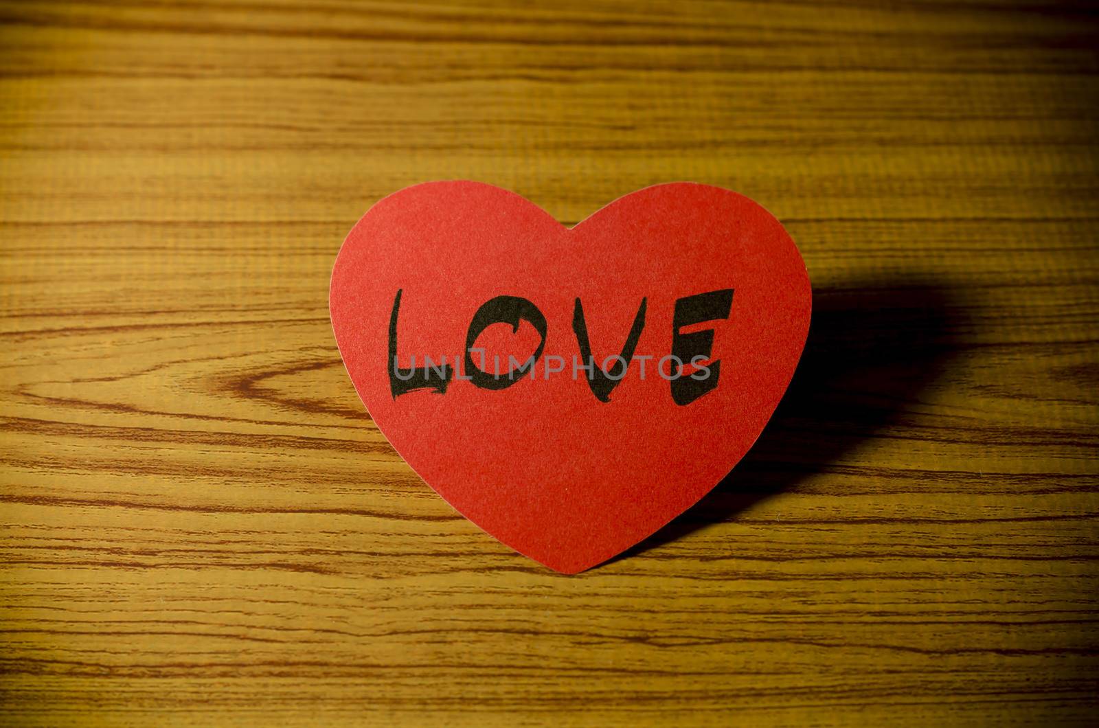 red heart word LOVE on wood vintage stlye background