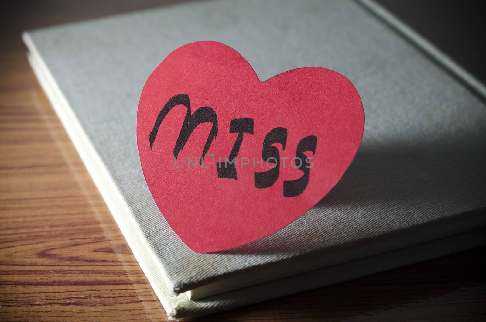 diary of love with notebook and heart on wood background