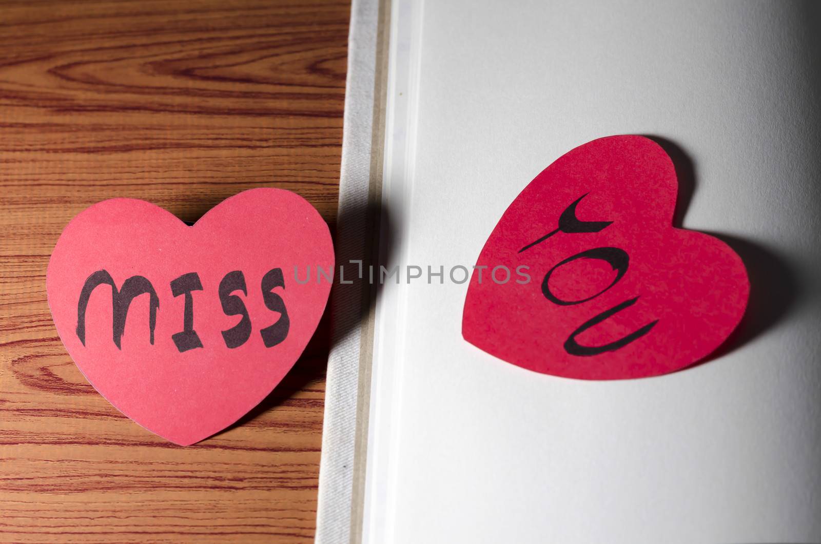 diary of love with notebook and heart on wood background