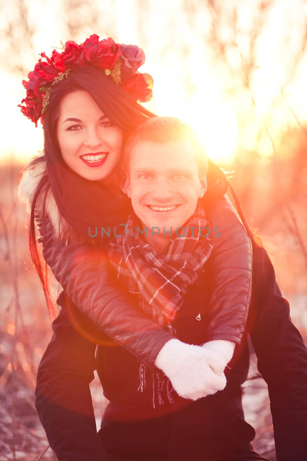 Beautiful young pair are smiling and having fun in sunlight
