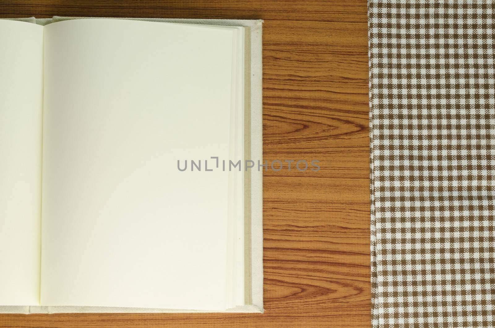 notebook with kitchen towel on wood background