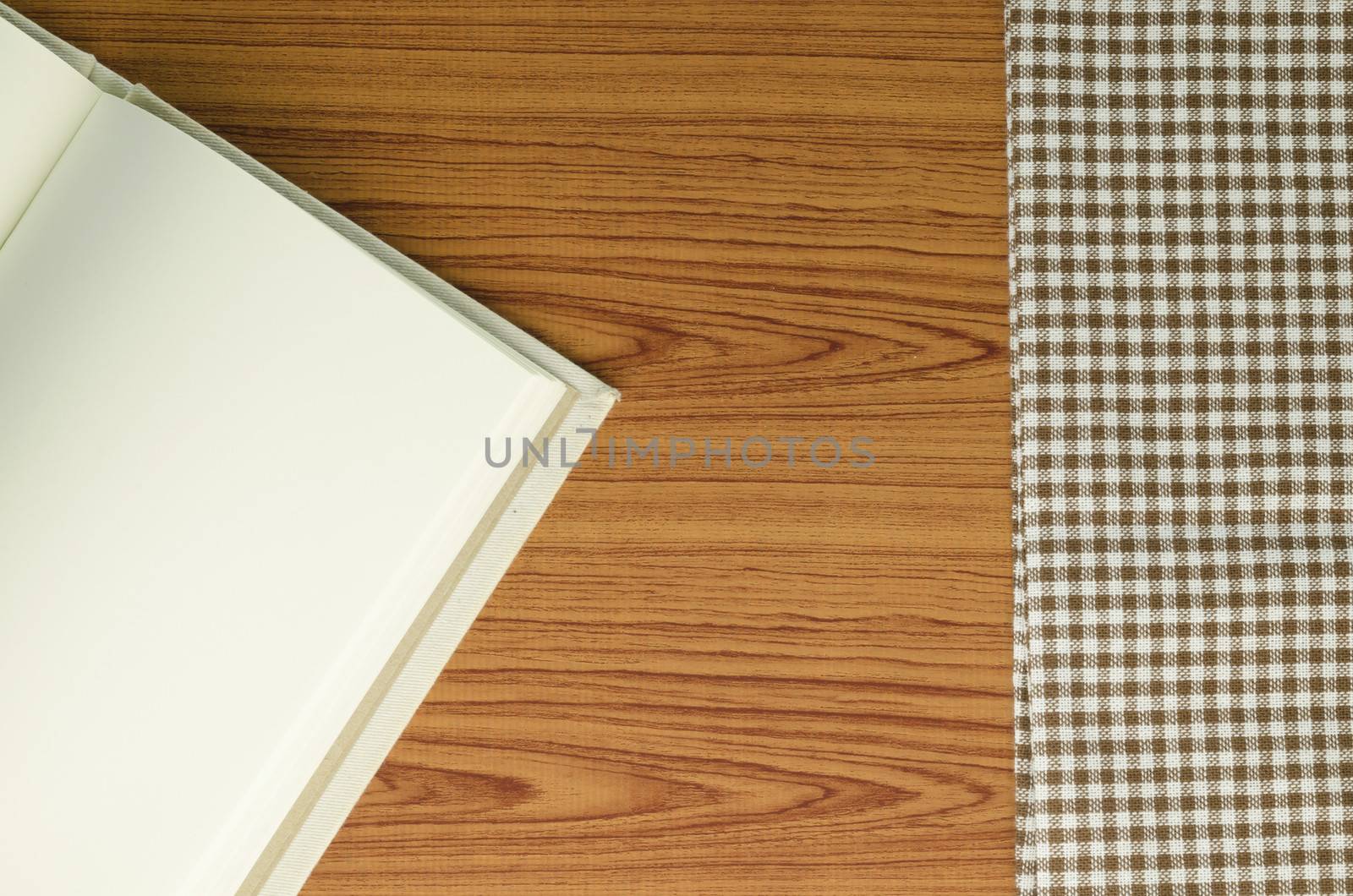 notebook with kitchen towel on wood background
