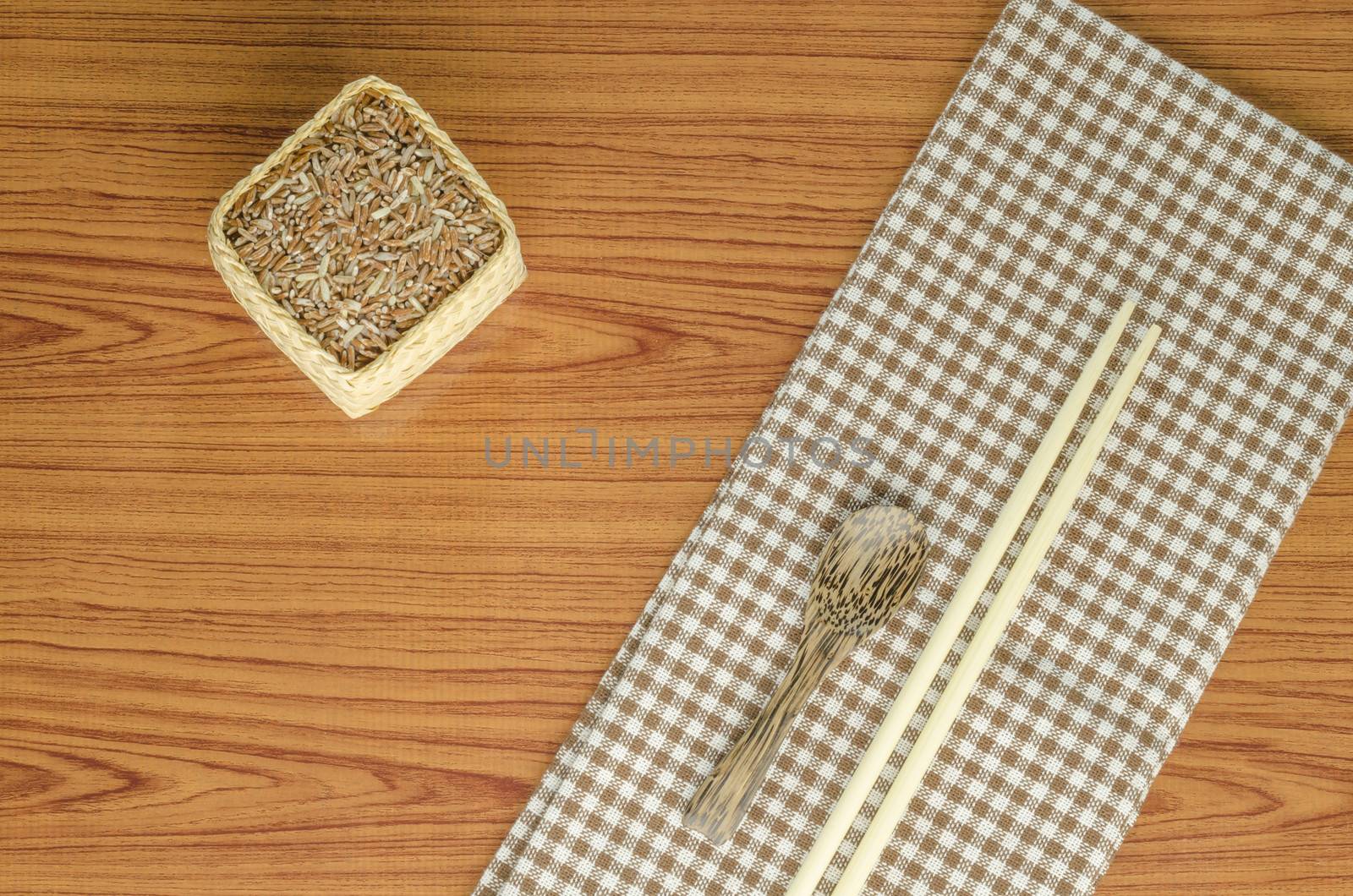 brown kitchen towel with spoon on wood background