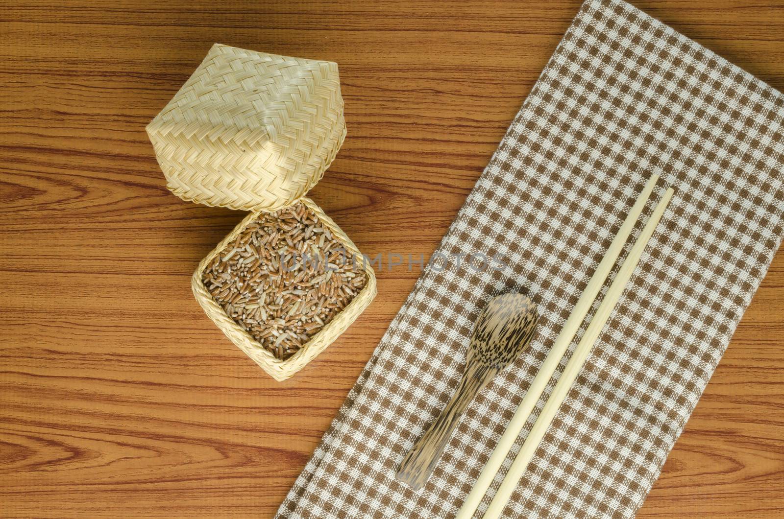 brown kitchen towel with spoon on wood background