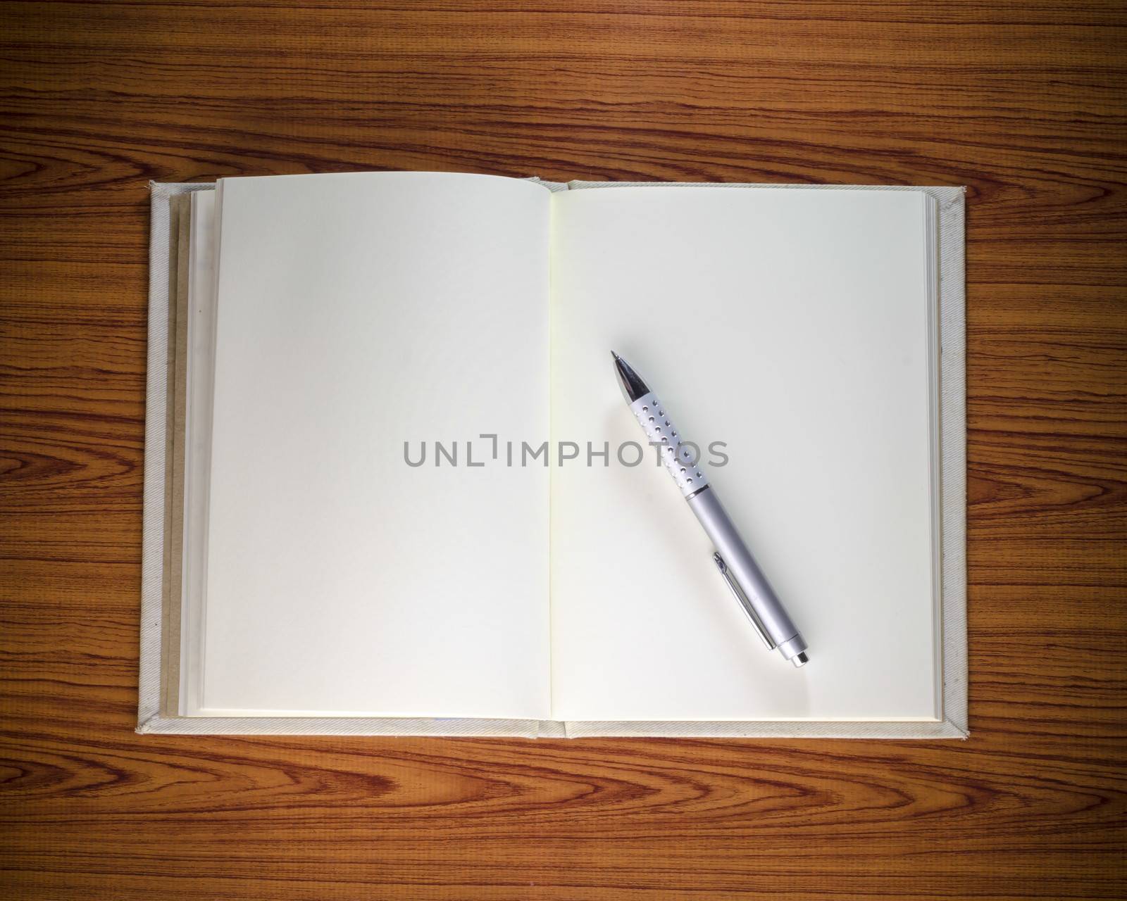 notebook with pen on wood background