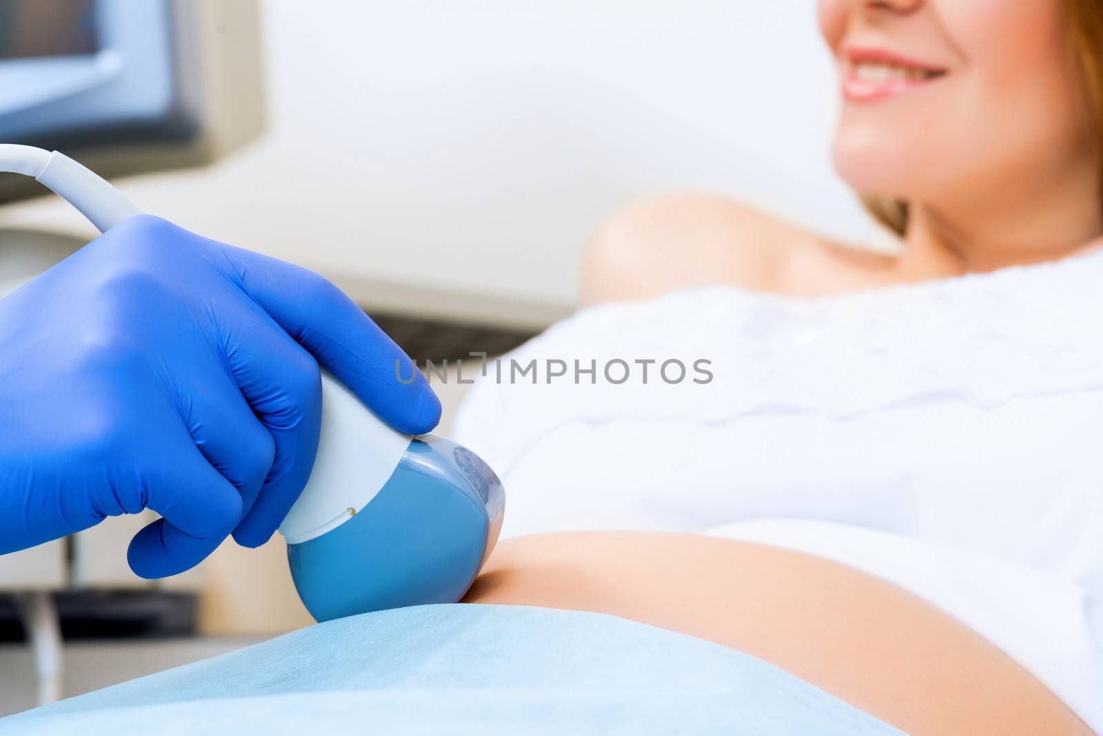 close-up of hands and abdominal ultrasound scanner by adam121