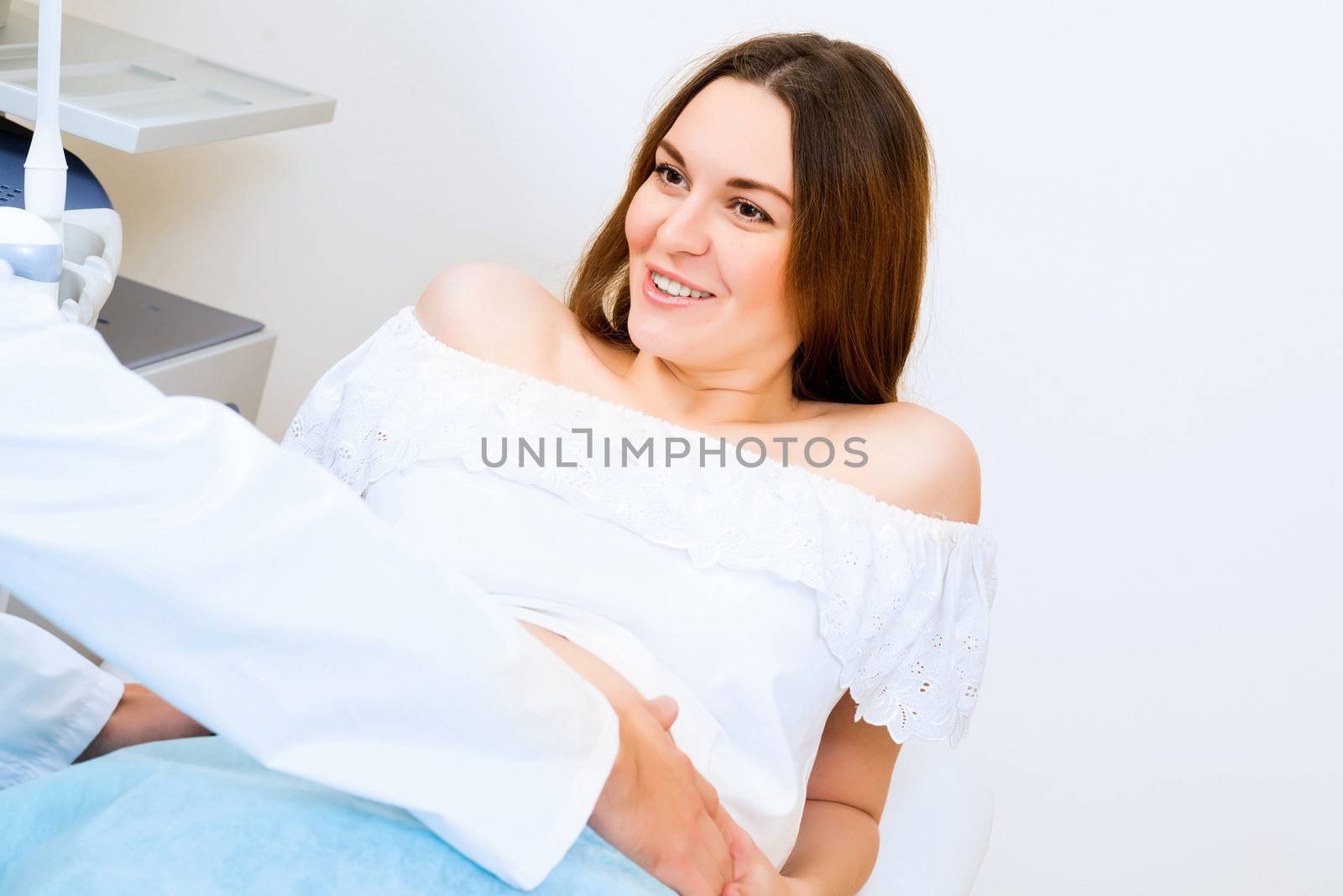 Young attractive pregnant woman on reception at the doctor, health check