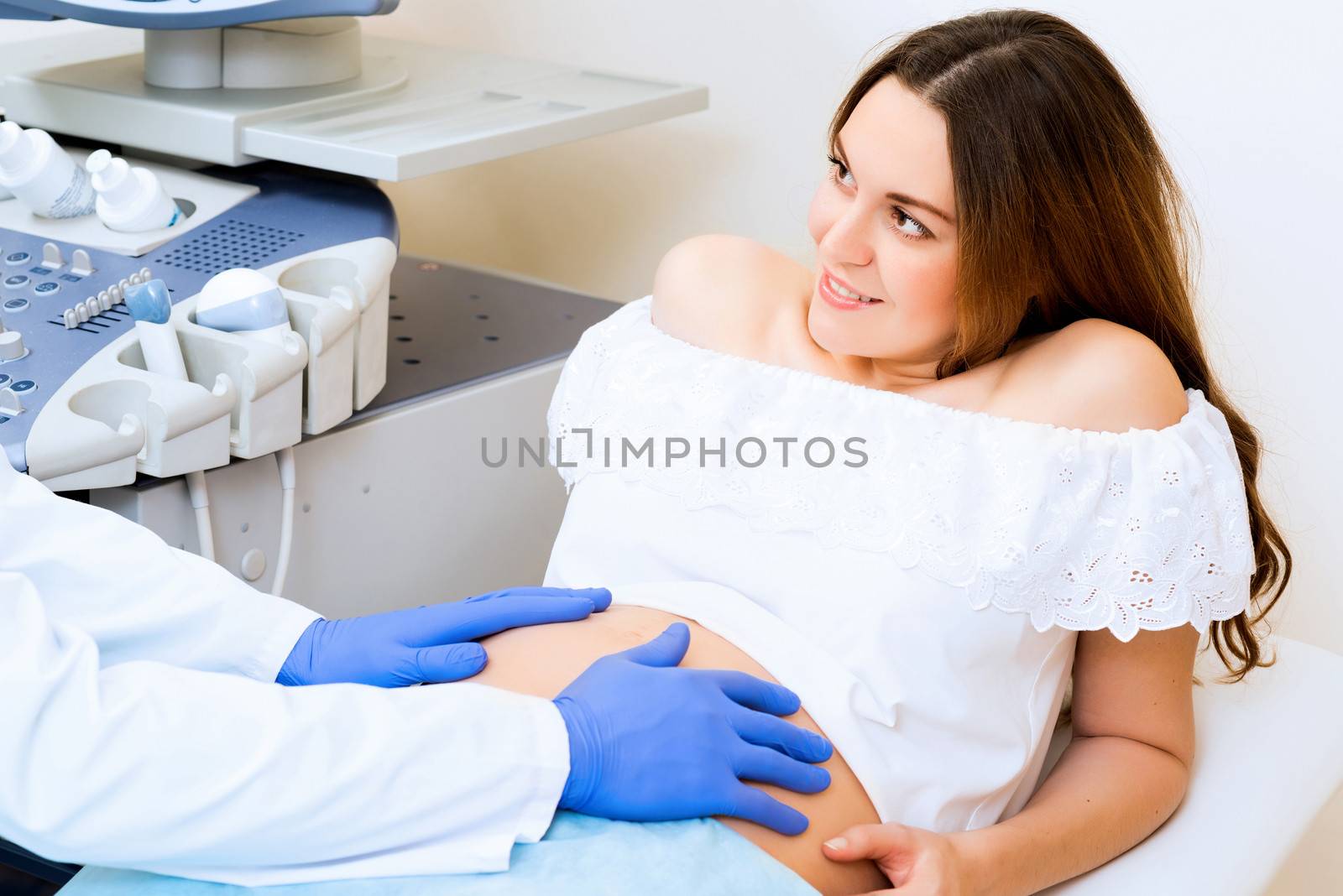 Young attractive pregnant woman on reception at the doctor, health check