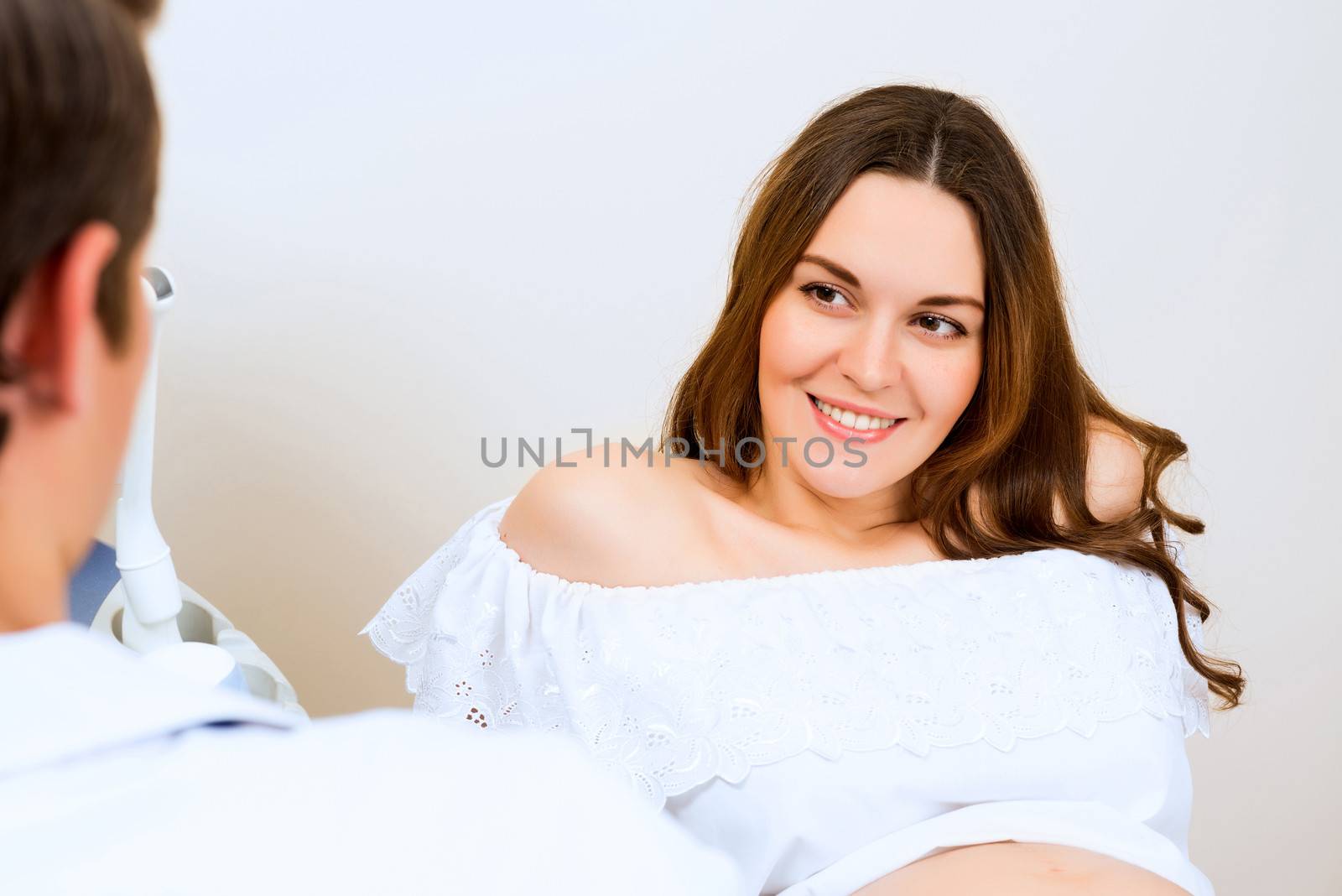 Young attractive pregnant woman on reception at the doctor, health check