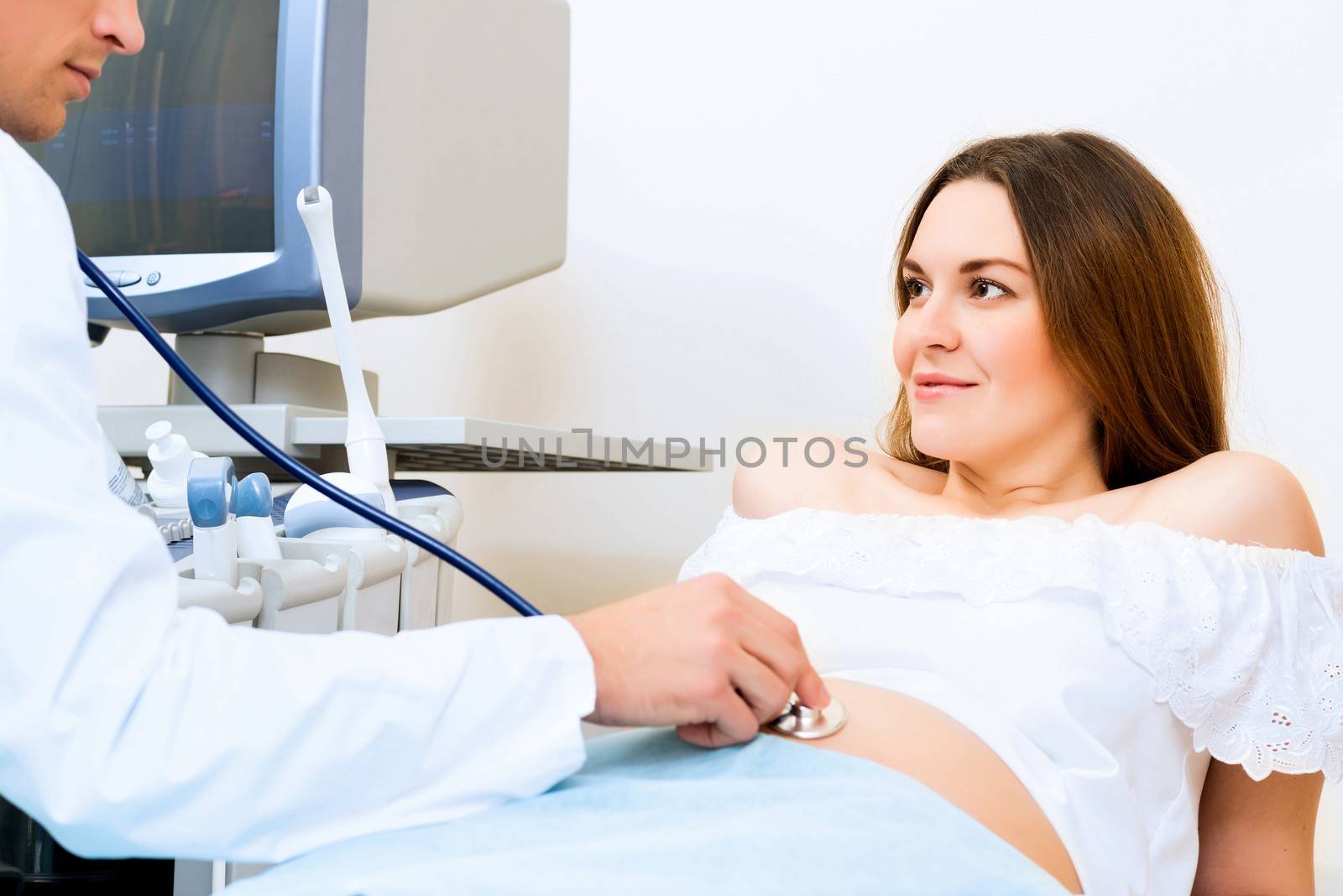 Young attractive pregnant woman on reception at the doctor, health check