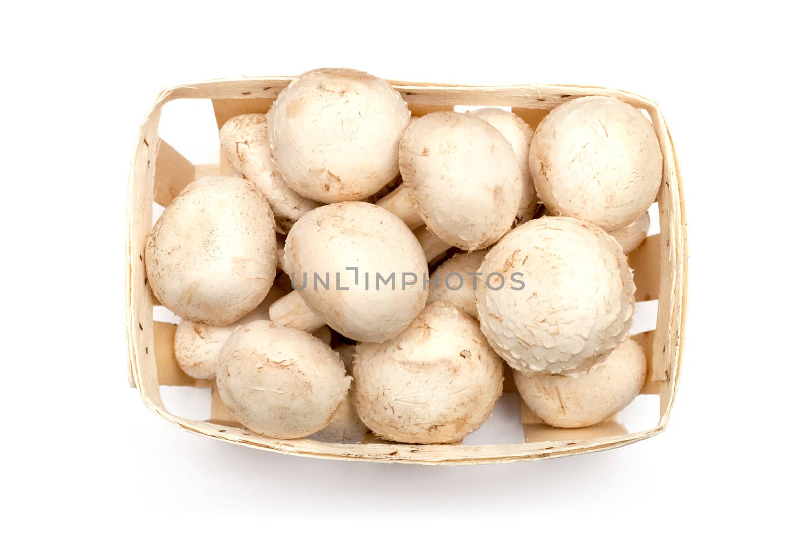 A lot of champignons in a wicker basket on white background