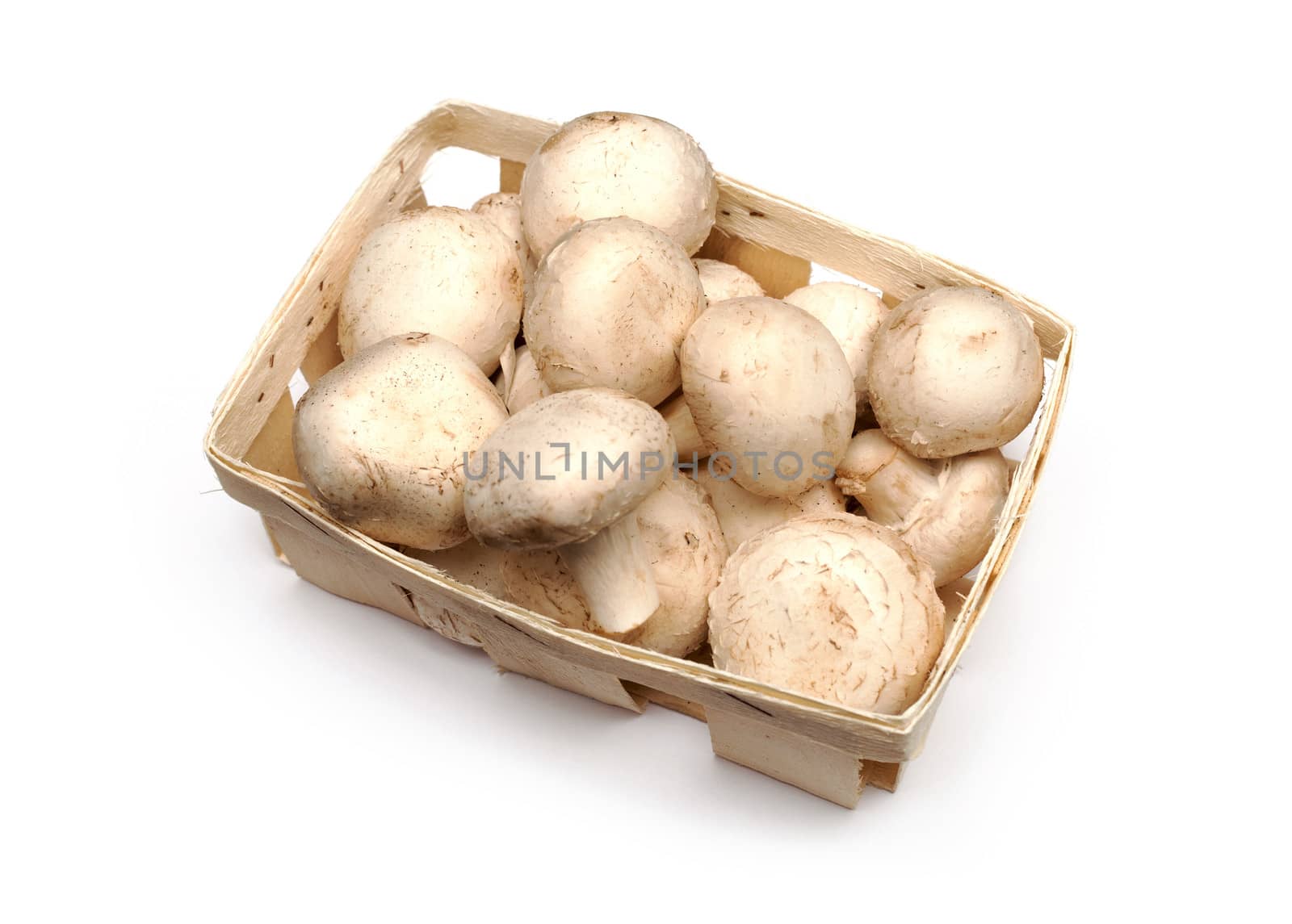 A lot of champignons in a wicker basket on white background