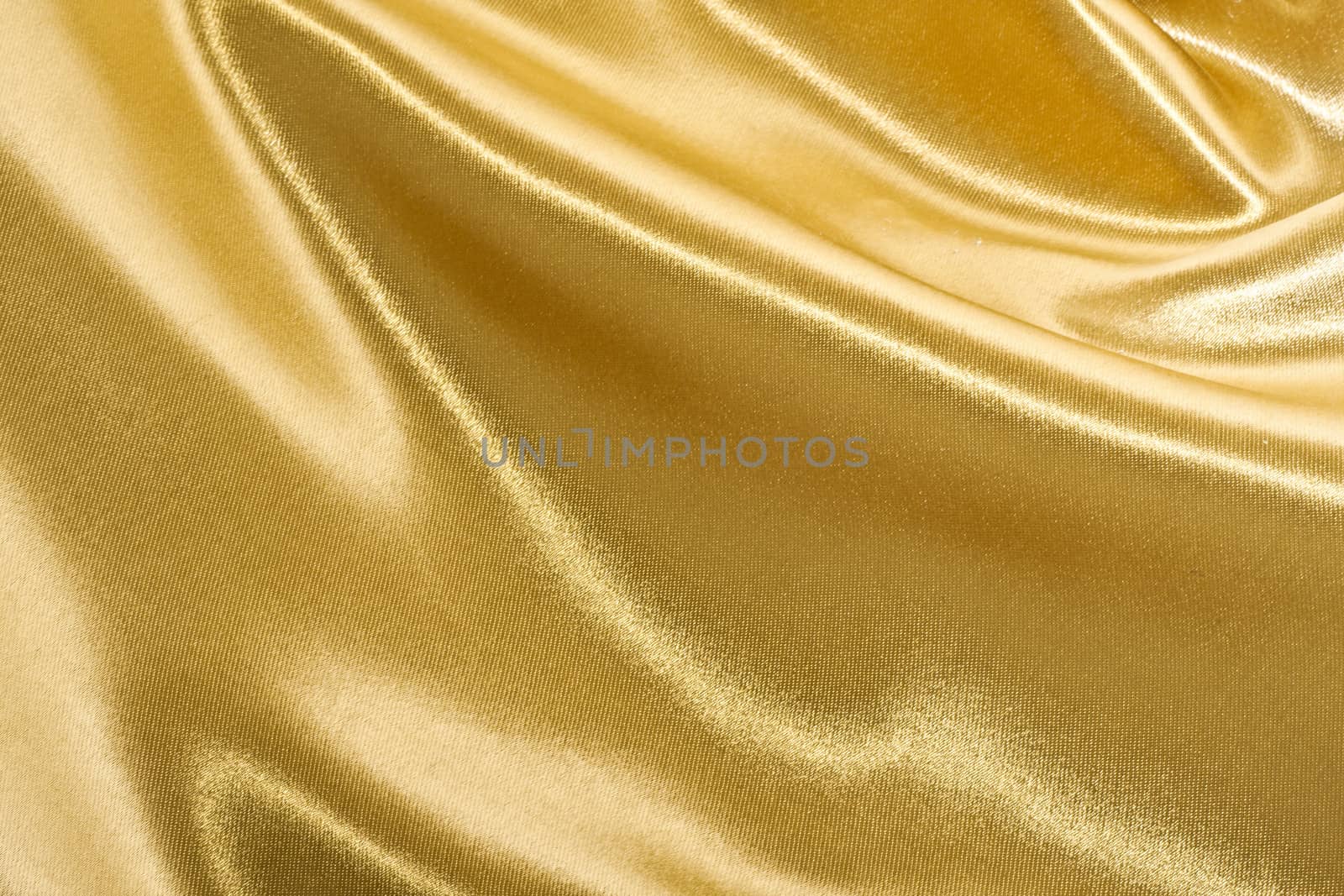 Golden satin or silk background with beautiful waves