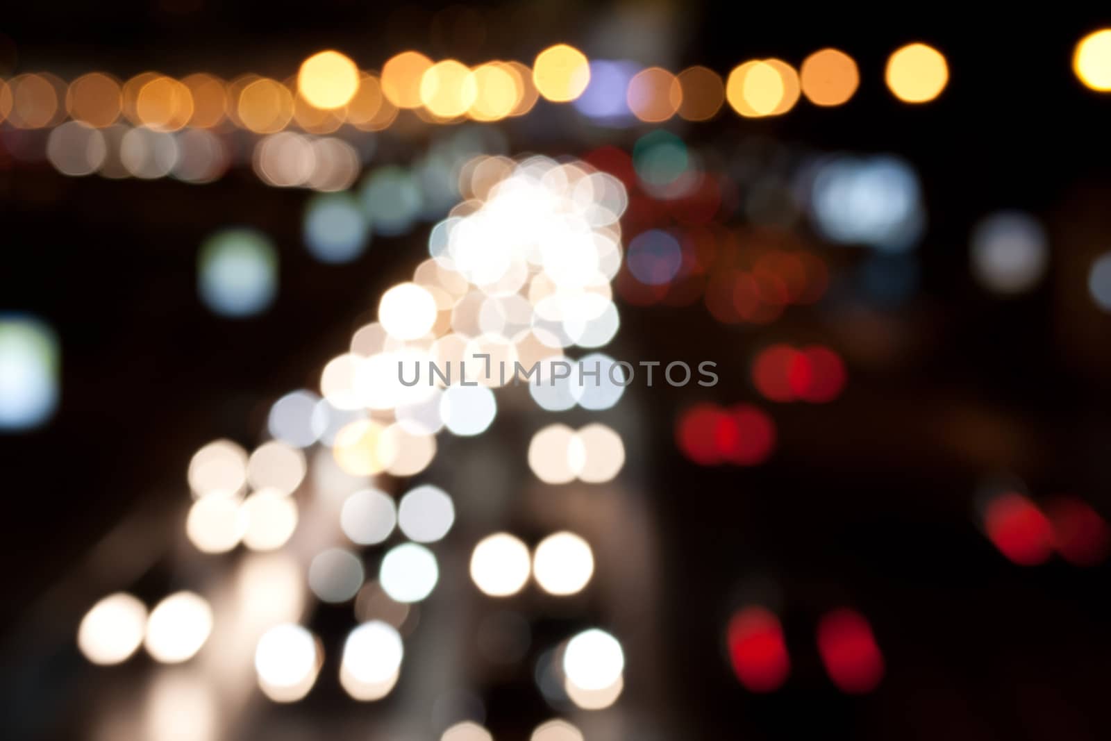 Road at night with traffic trails and blurred lights