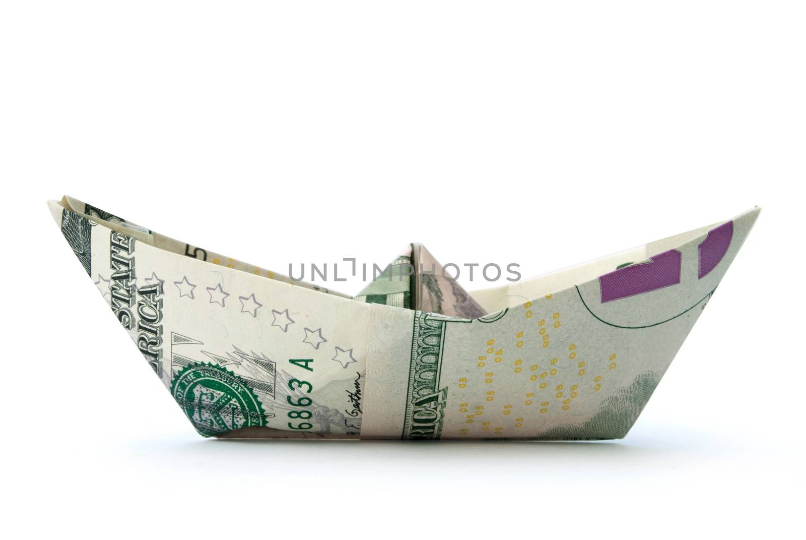 Paper boat made from dollar banknotes over a white background 