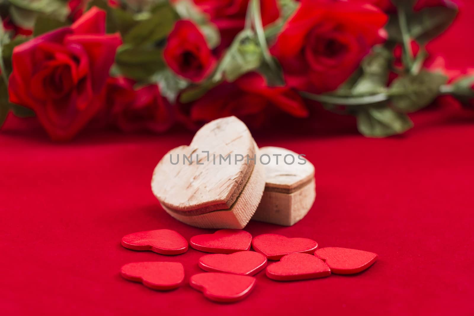 Hearts on red with roses in the background by snowwhite