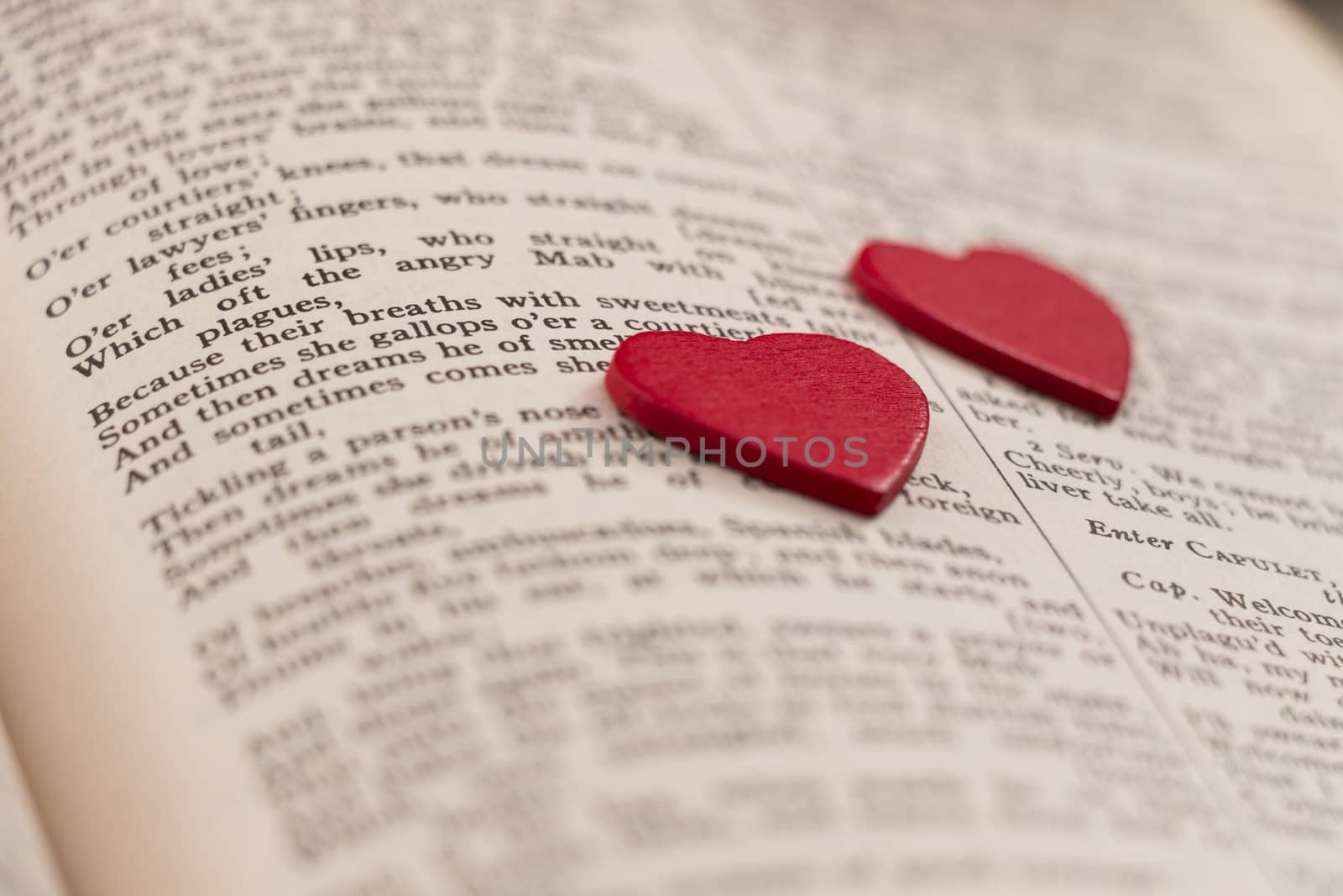 Two hearts on a book page by snowwhite
