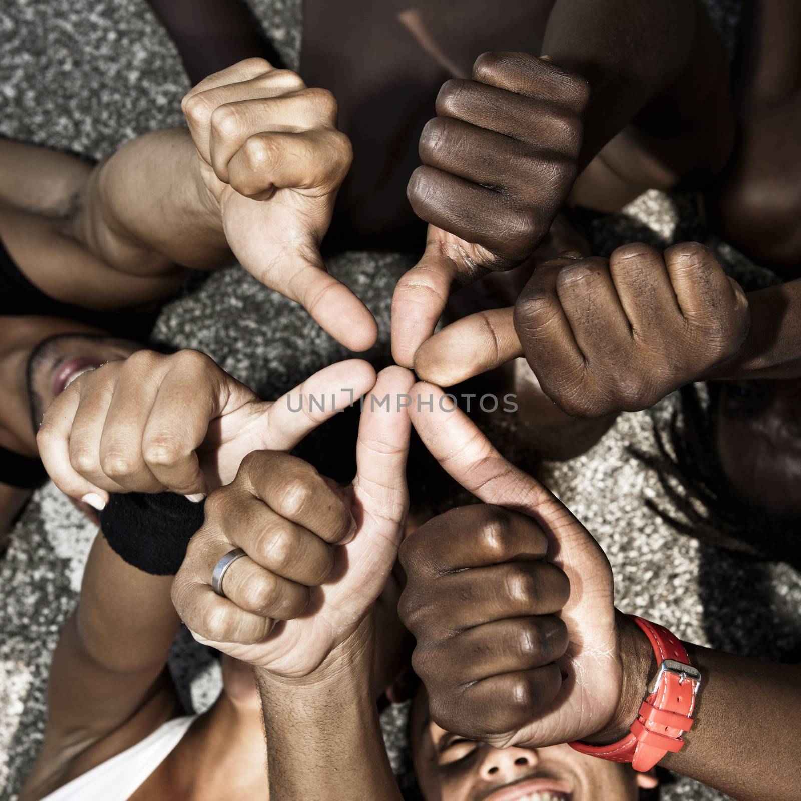 A group of mixed race people with hands doing thumbs up
