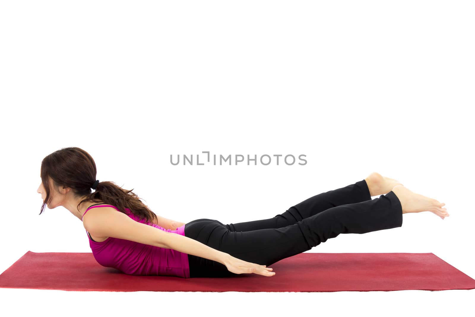 Young woman doing Locust Pose in Yoga