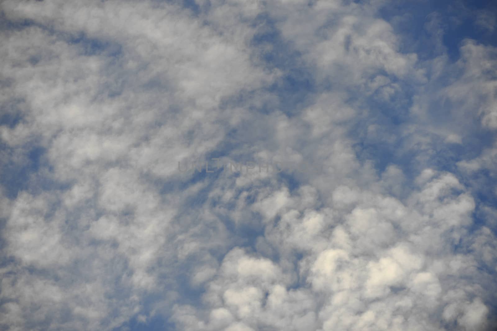  White sparse clouds over blue sky 