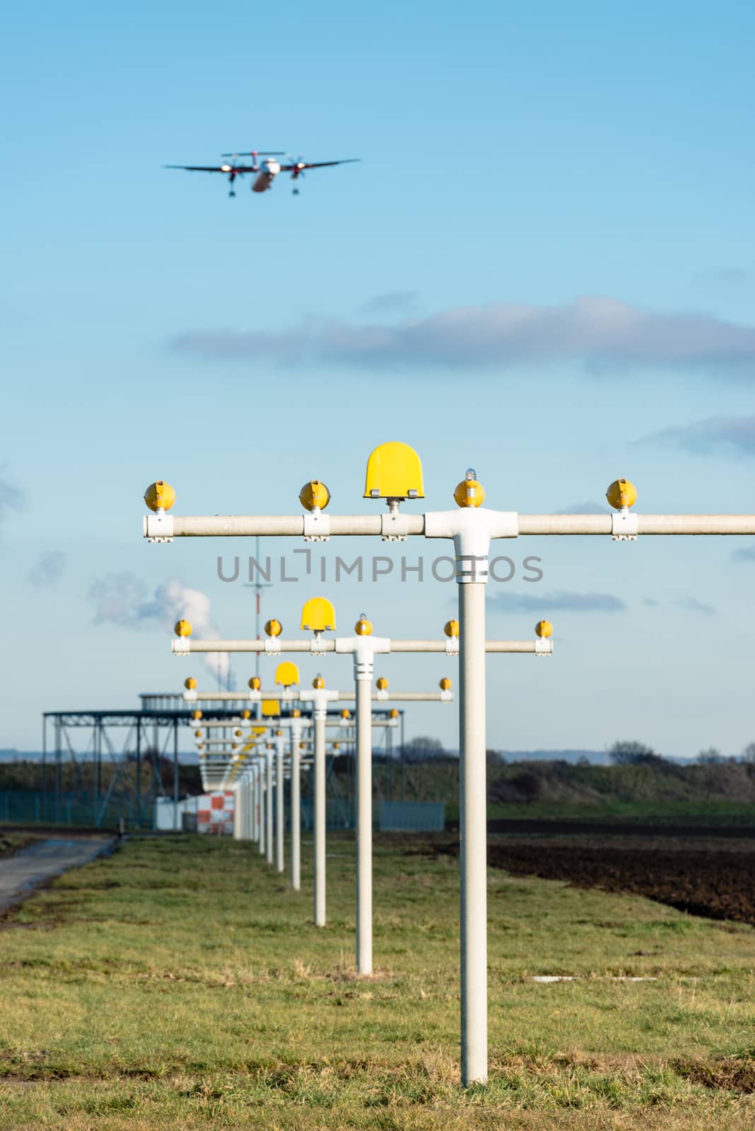 Airport landing lights with airplane approaching runway lighting and radar