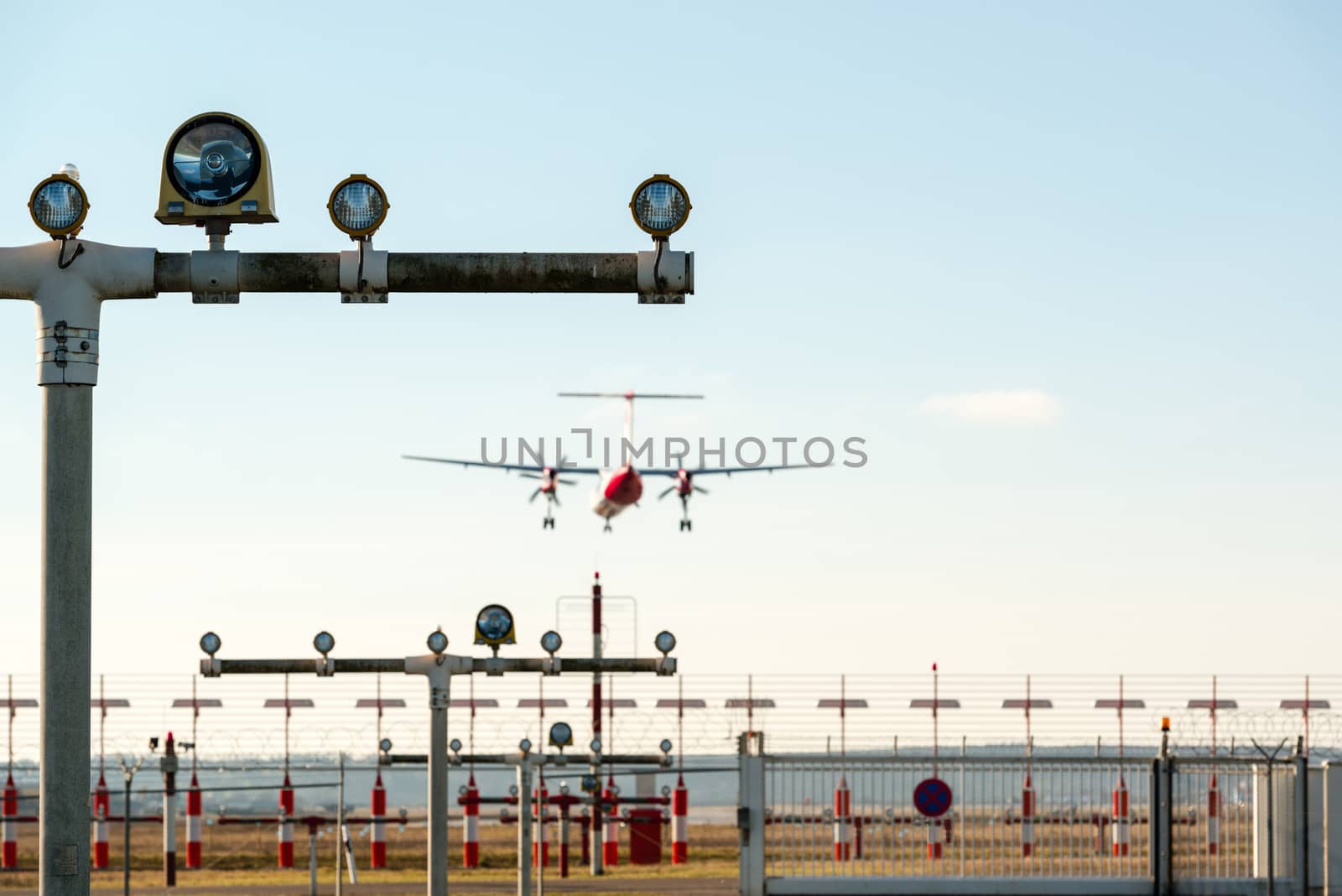 Airport landing lights with airplane approaching runway lighting.