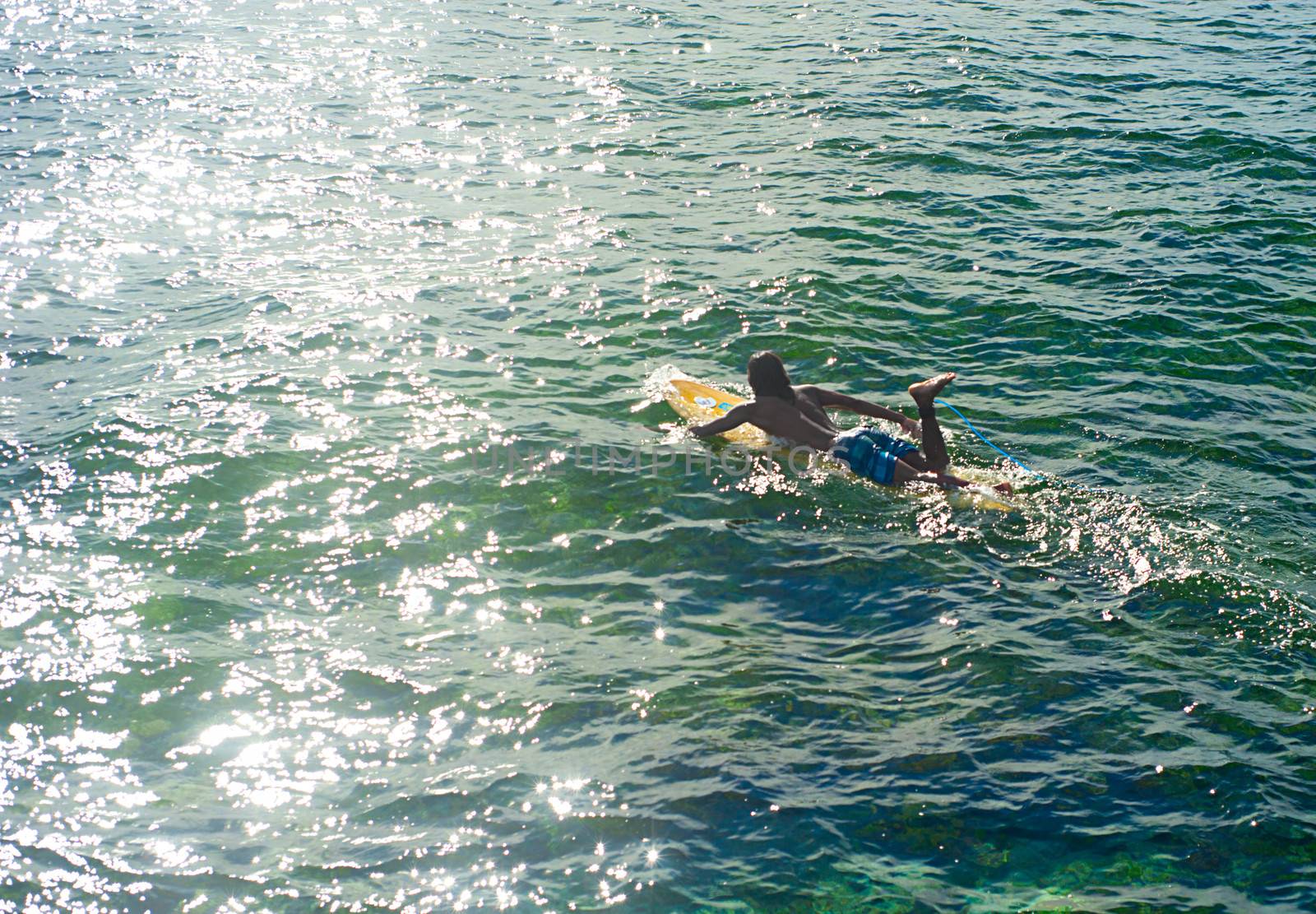 Surfer swiming by joyfull