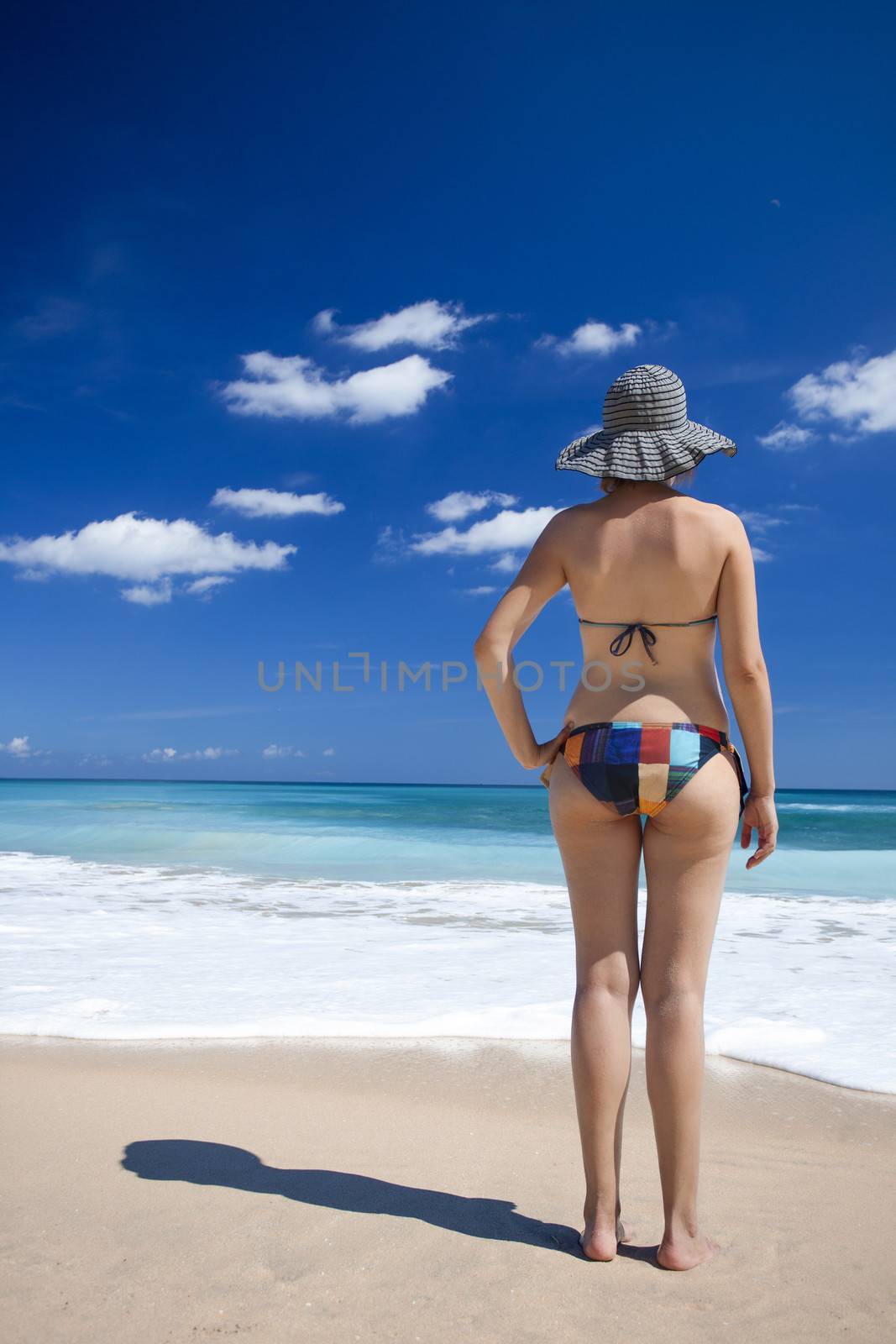 Beautiful young woman enjoying the summer in a tropical beach