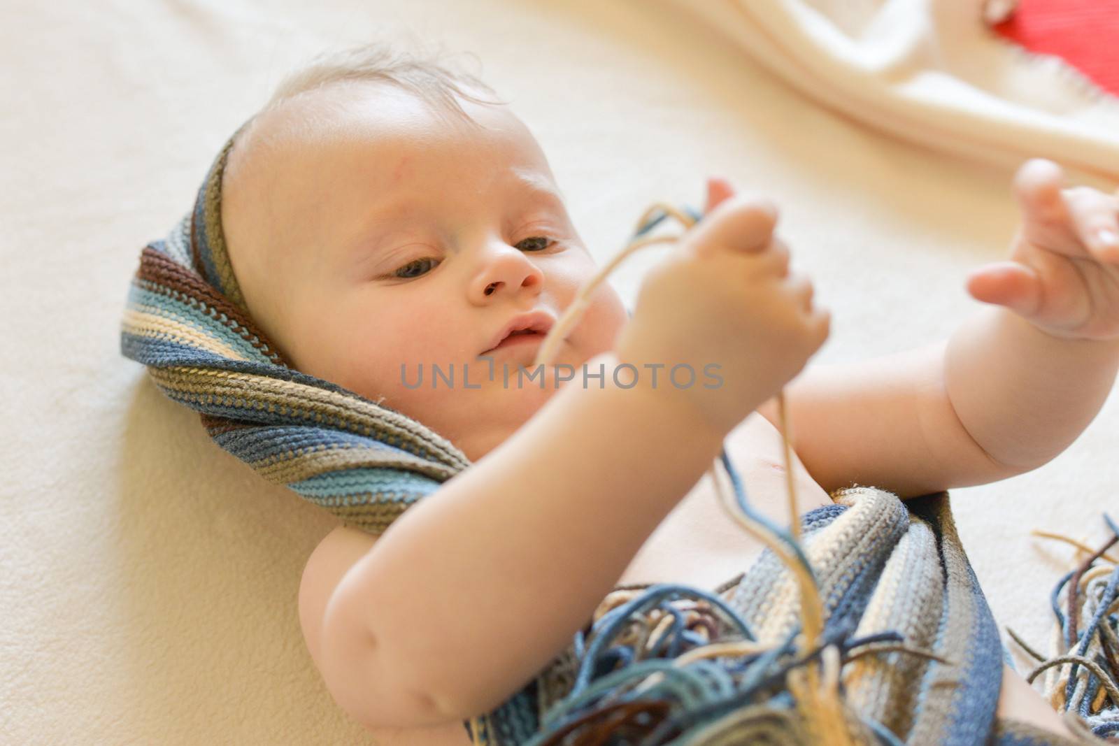 Portrait of a seven month old baby boy looking curious at the camera