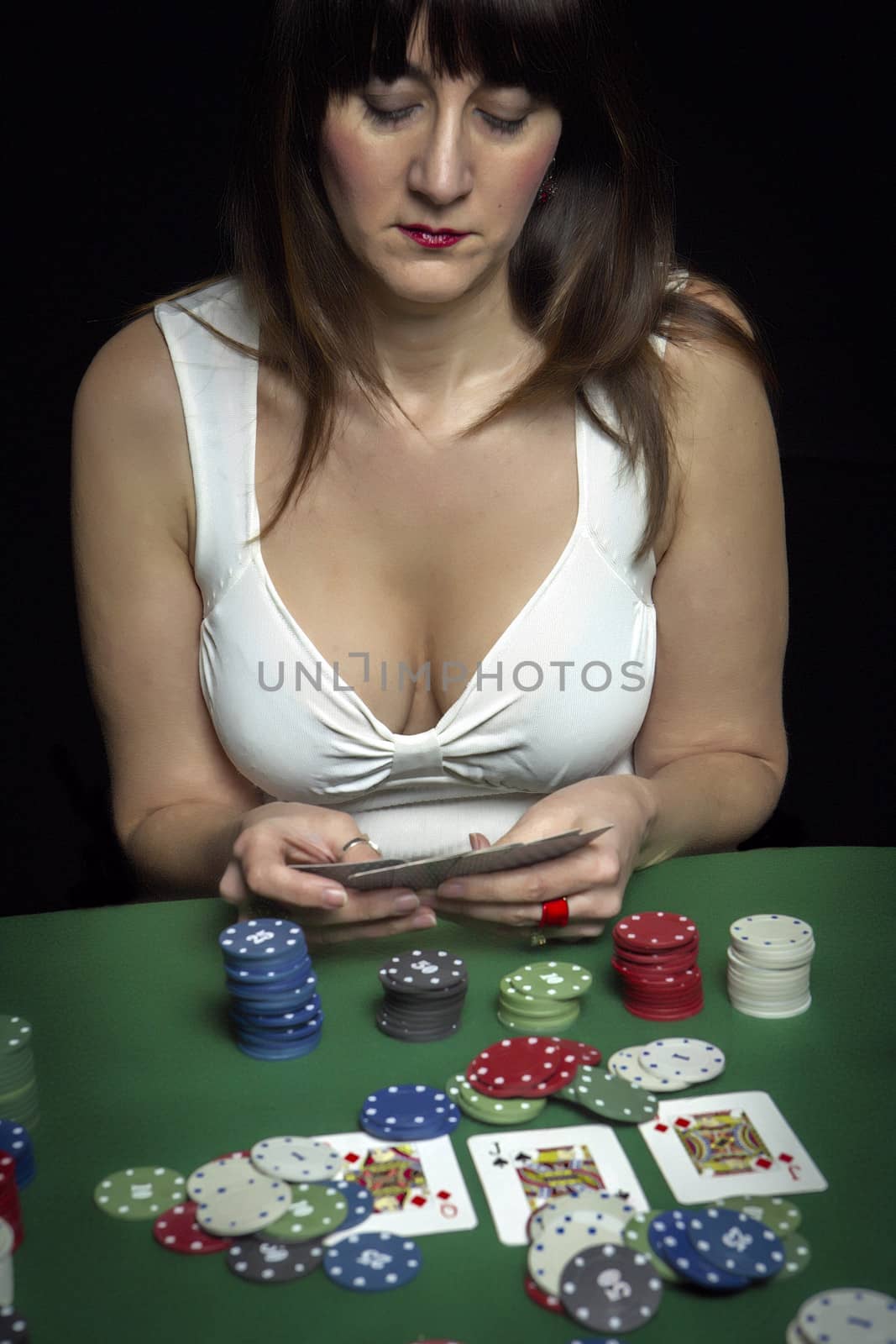 Very beautiful woman playing texas hold'em poker  by digicomphoto